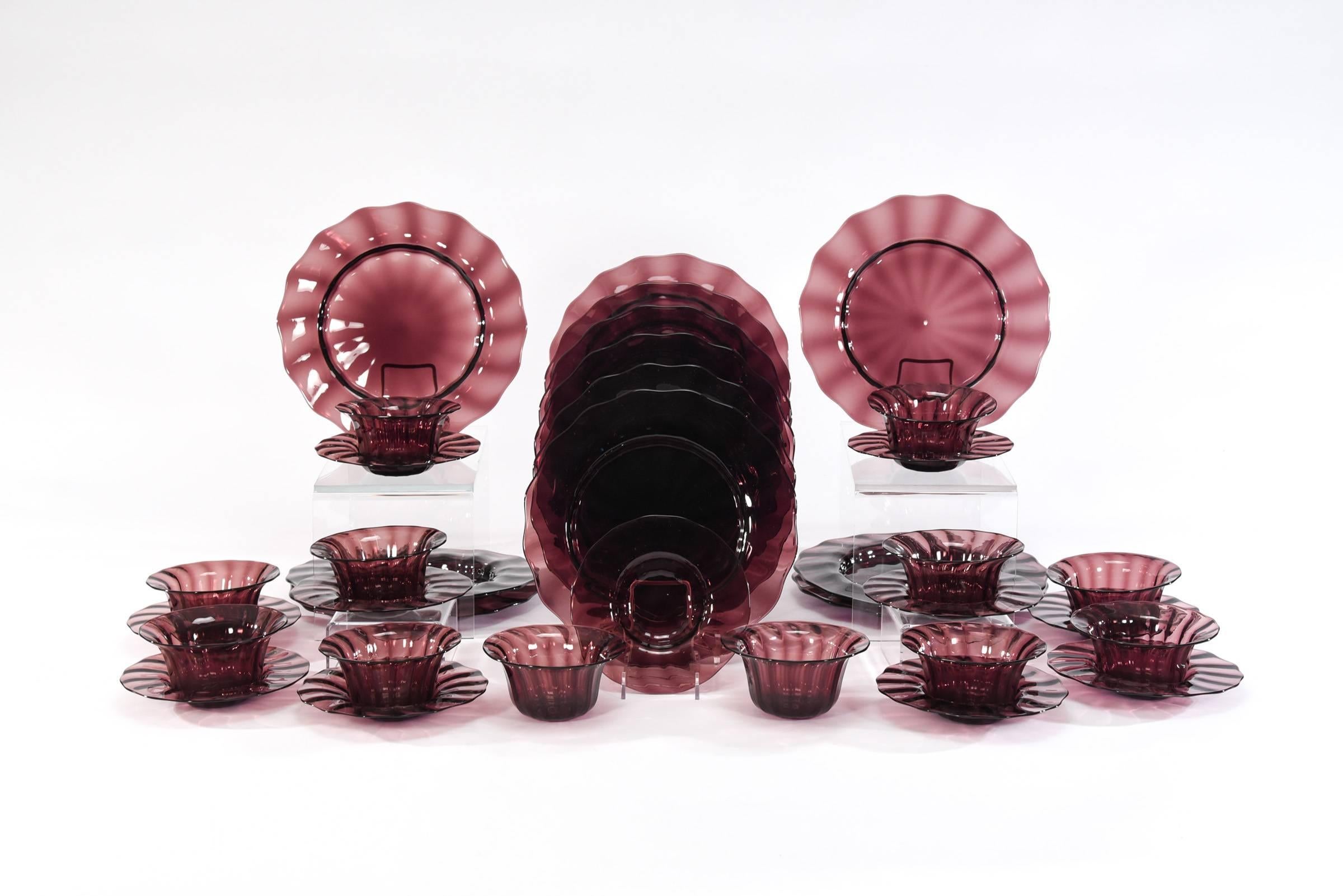 What an amazing collection of Steuben's hand blown amethyst crystal dinner service for 12! All hand blown in the more desirable form of optic ribbing that gives each piece a special quality of subtle wavy ribbing. The set includes large dinner