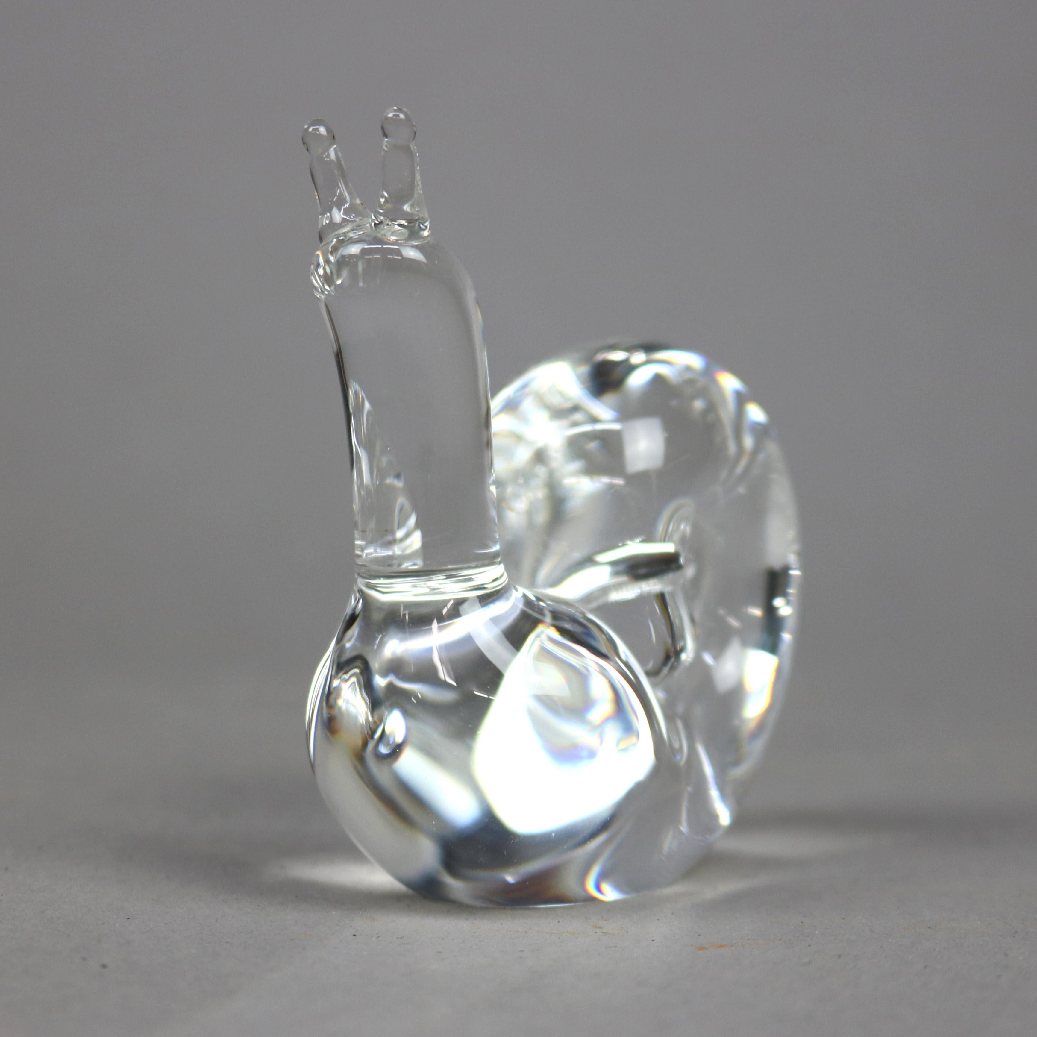 A figural paperweight by Steuben offers colorless art glass in snail form, unsigned, 20th century

Measures- 3.25''H x 1.5''W x 2.75''D

Catalogue Note: Ask about DISCOUNTED DELIVERY RATES available to most regions within 1,500 miles of New York.