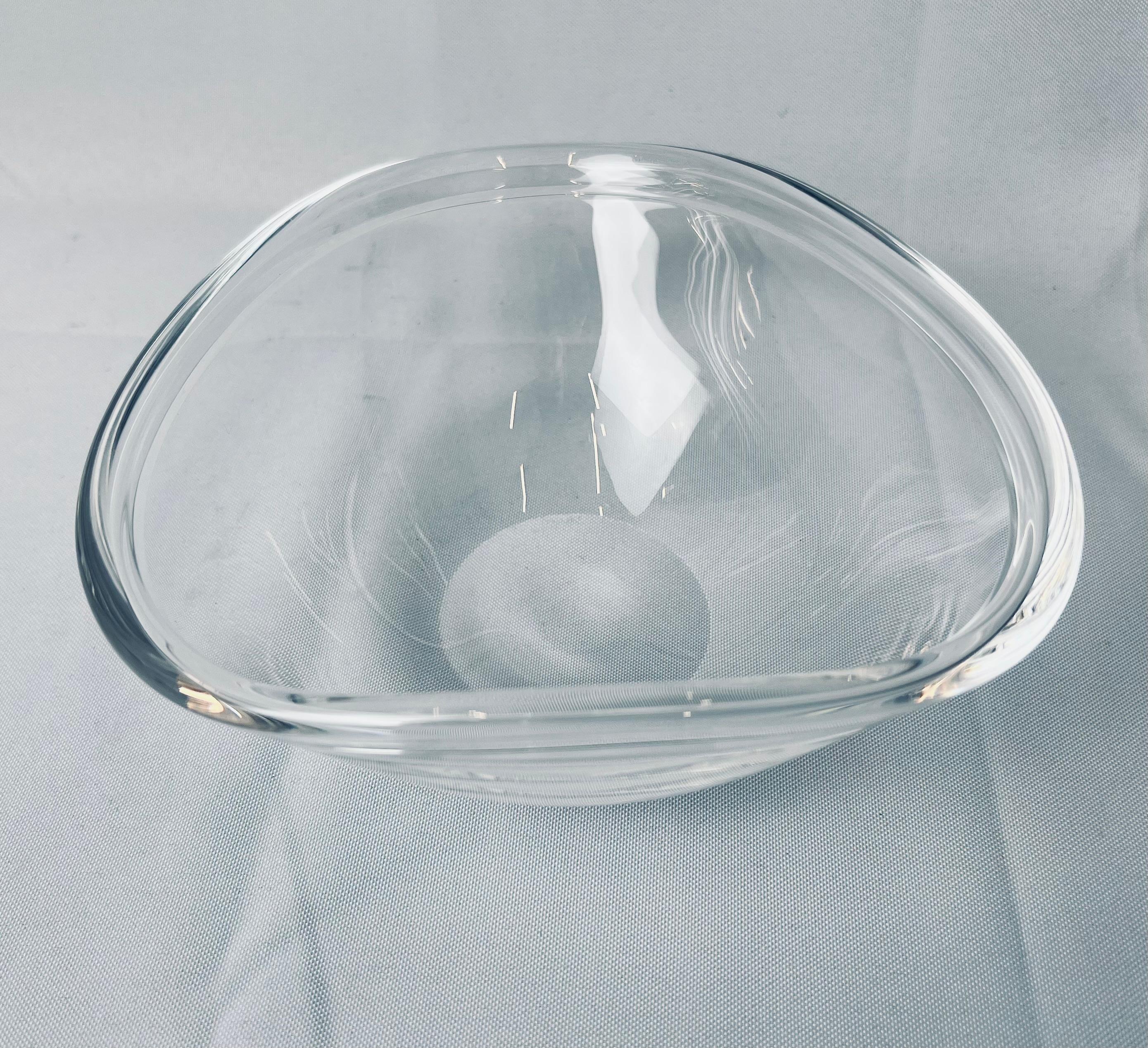 Steuben clear glass blown bowl with a wavy rolled over edge. The underside is polished and scribe signed.

Measures: H-3