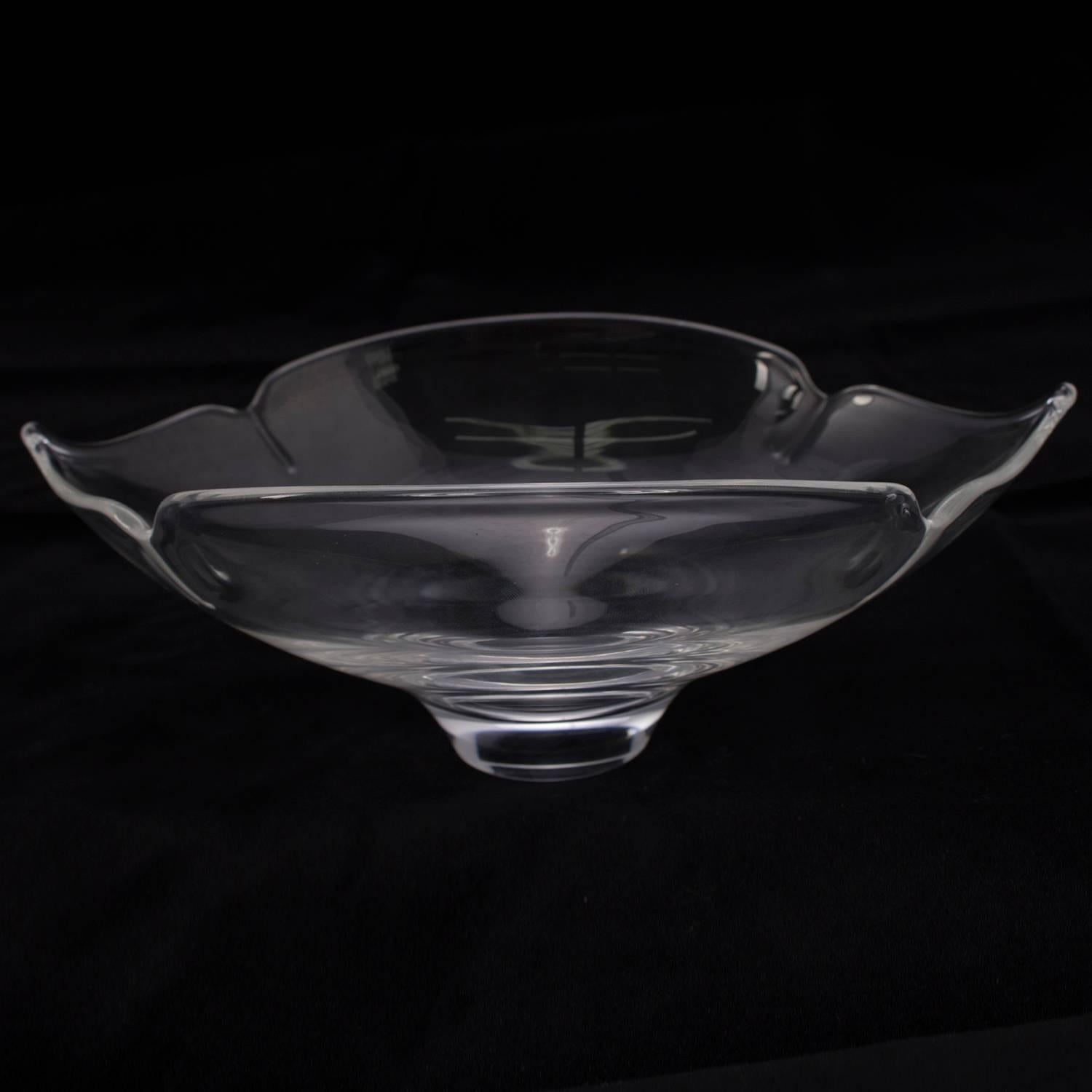 Steuben crystal console bowl features freeform elongated and low profile stylized poppy flower quatrefoil form with four leaves or petals and pedestal base, designed by Donald Pollard, signed on base, 20th century

Measures: 3.5
