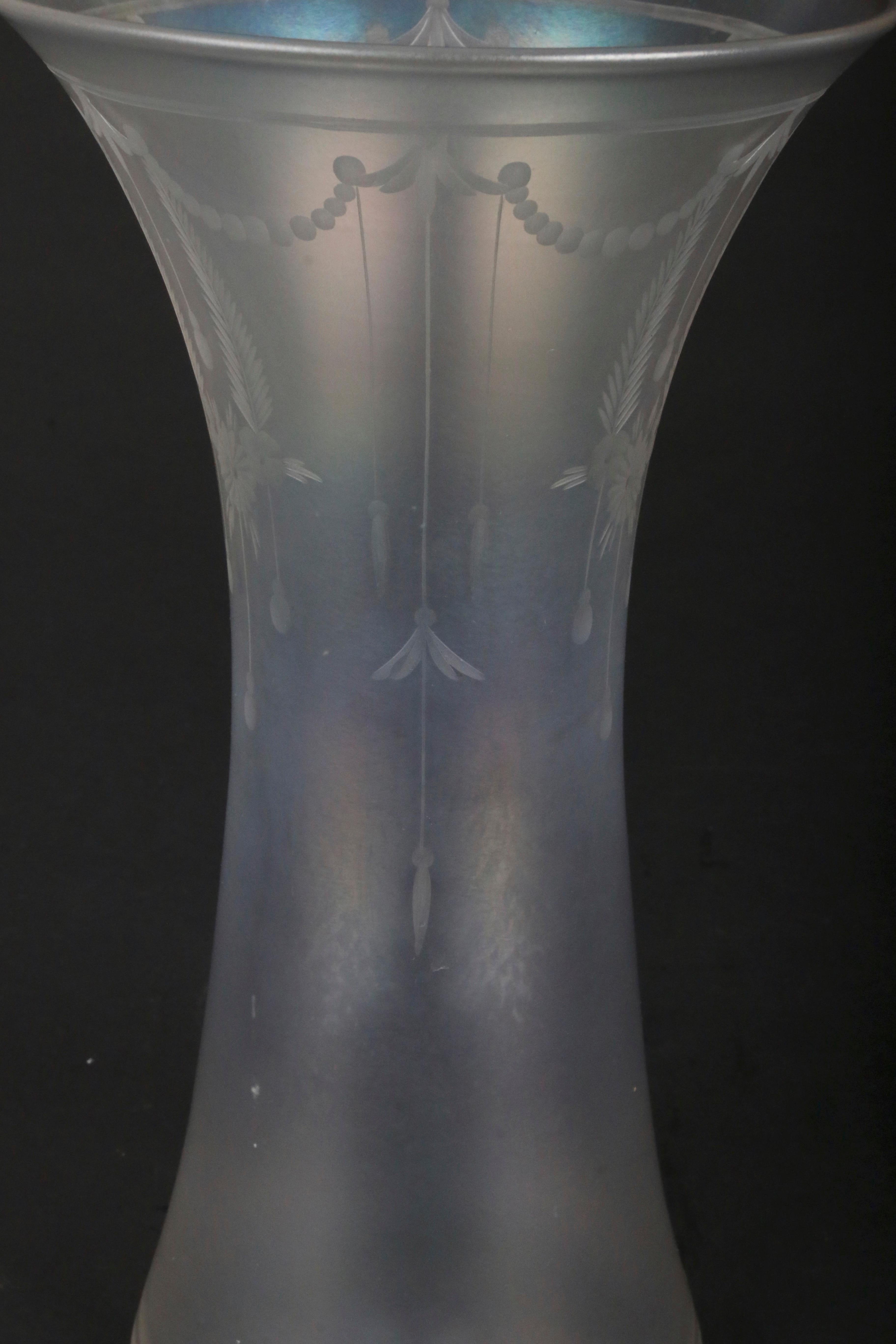 This hourglass shaped vase is made of special iridescent glass called verre de soie or “glass of silk” that was invented by Frederick Carder at Steuben. The Corning Museum of Glass says that 