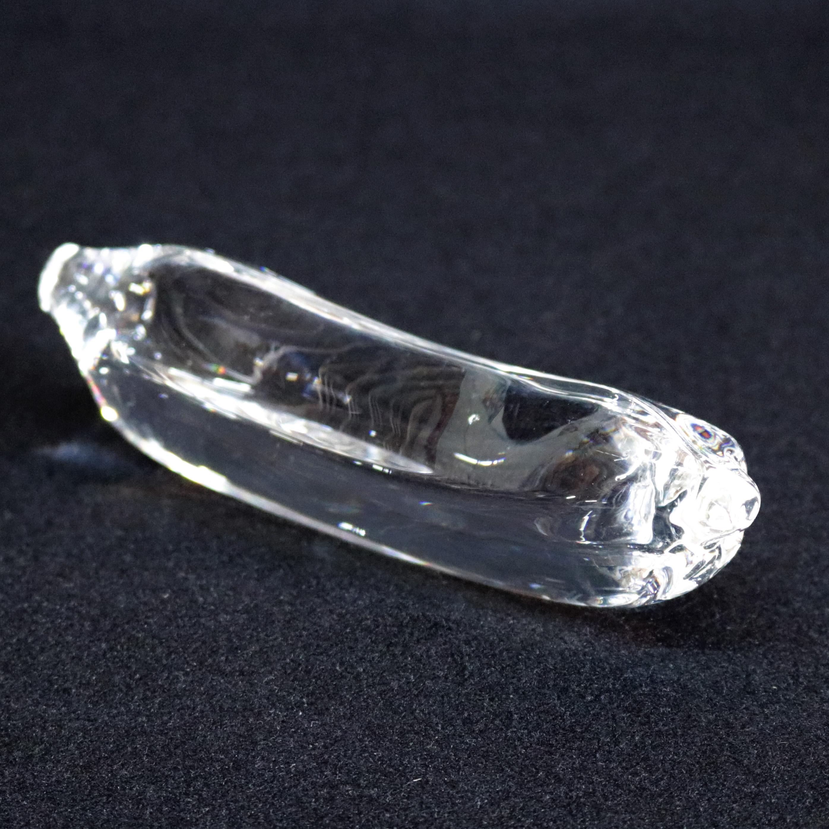 Midcentury Steuben figurative mouth blown crystal fruit sculptural paperweight features colorless art glass in full body form of Banana designed in the 1940s by Corning Museum of glass, New York, NY, signed on base, 20th century.

Measures - 2.5