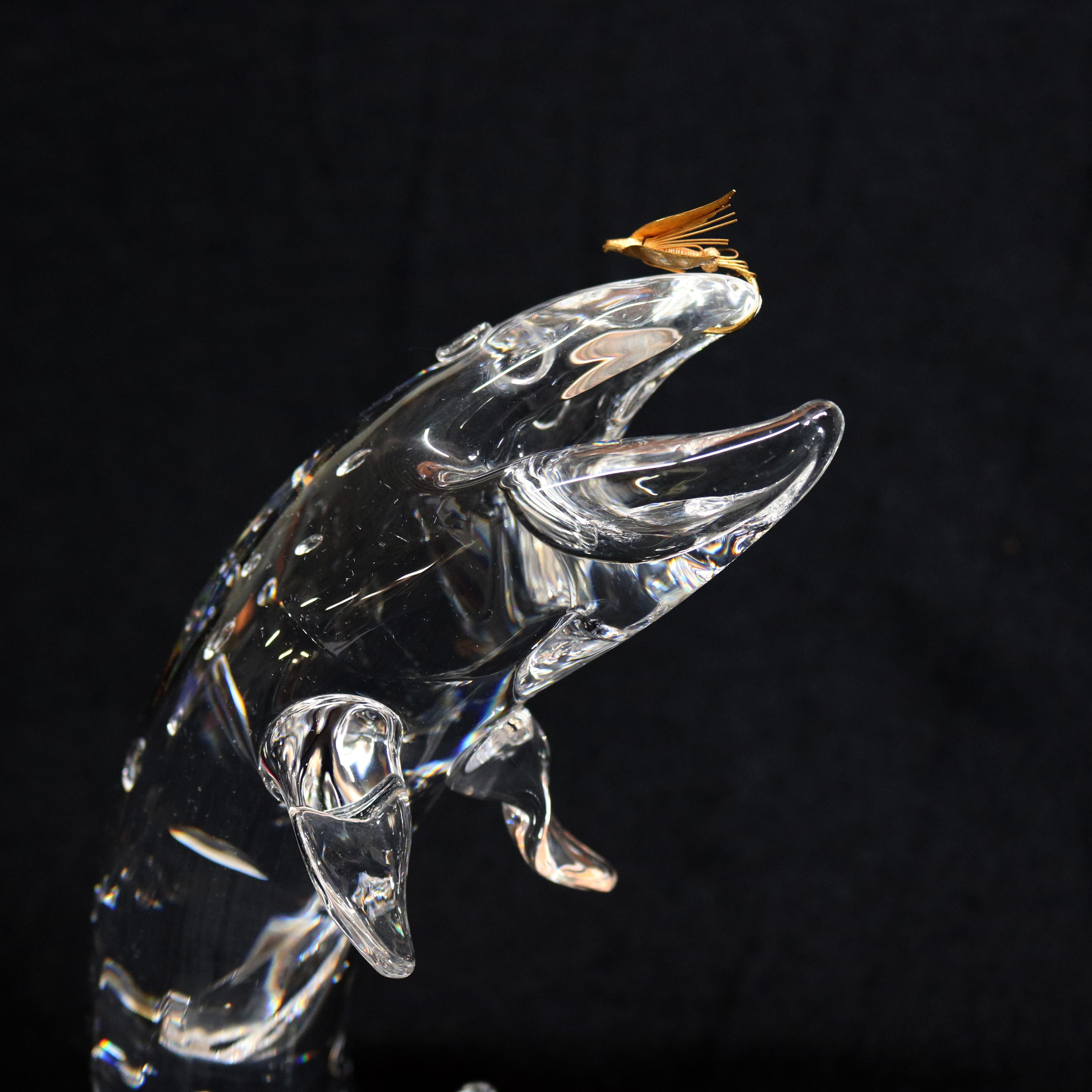 Midcentury Steuben figurative mouth blown crystal sculptural paperweight features colorless art glass in full body form of Trout leaping to catch a golden 18 kt Royal Coachman fly, the trout's skin with water drops, represented by bubbles of trapped