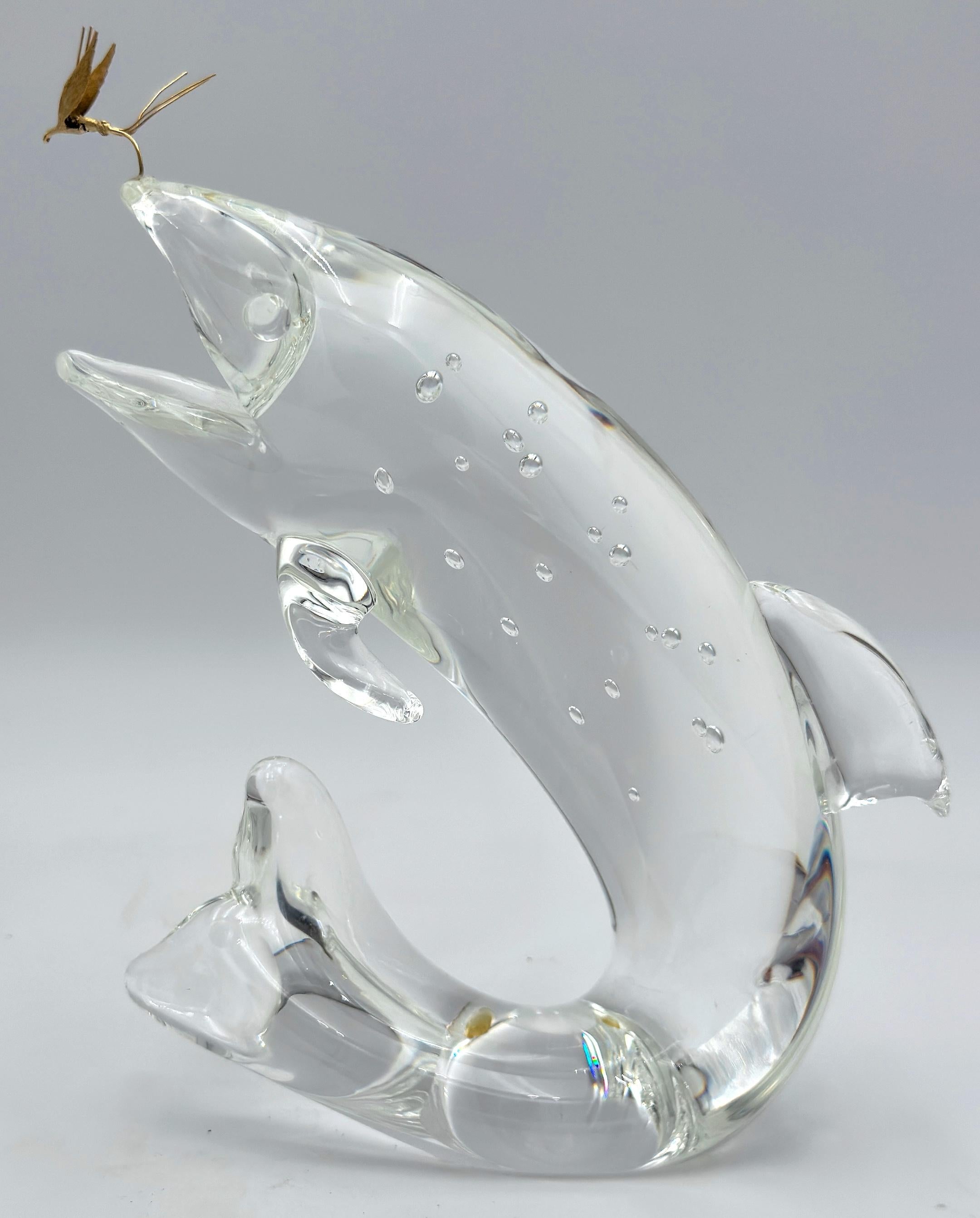 Steuben Glass & 18K Gold “Trout & Fly” by James Houston, Introduced 1966

American, Steuben Glass Works, Corning, New York
Crystal and 18k Gold • Signed • H. 8 in. × W. 6.5 in. × D. 2 in.

A masterwork of American glass artistry, this signed Steuben