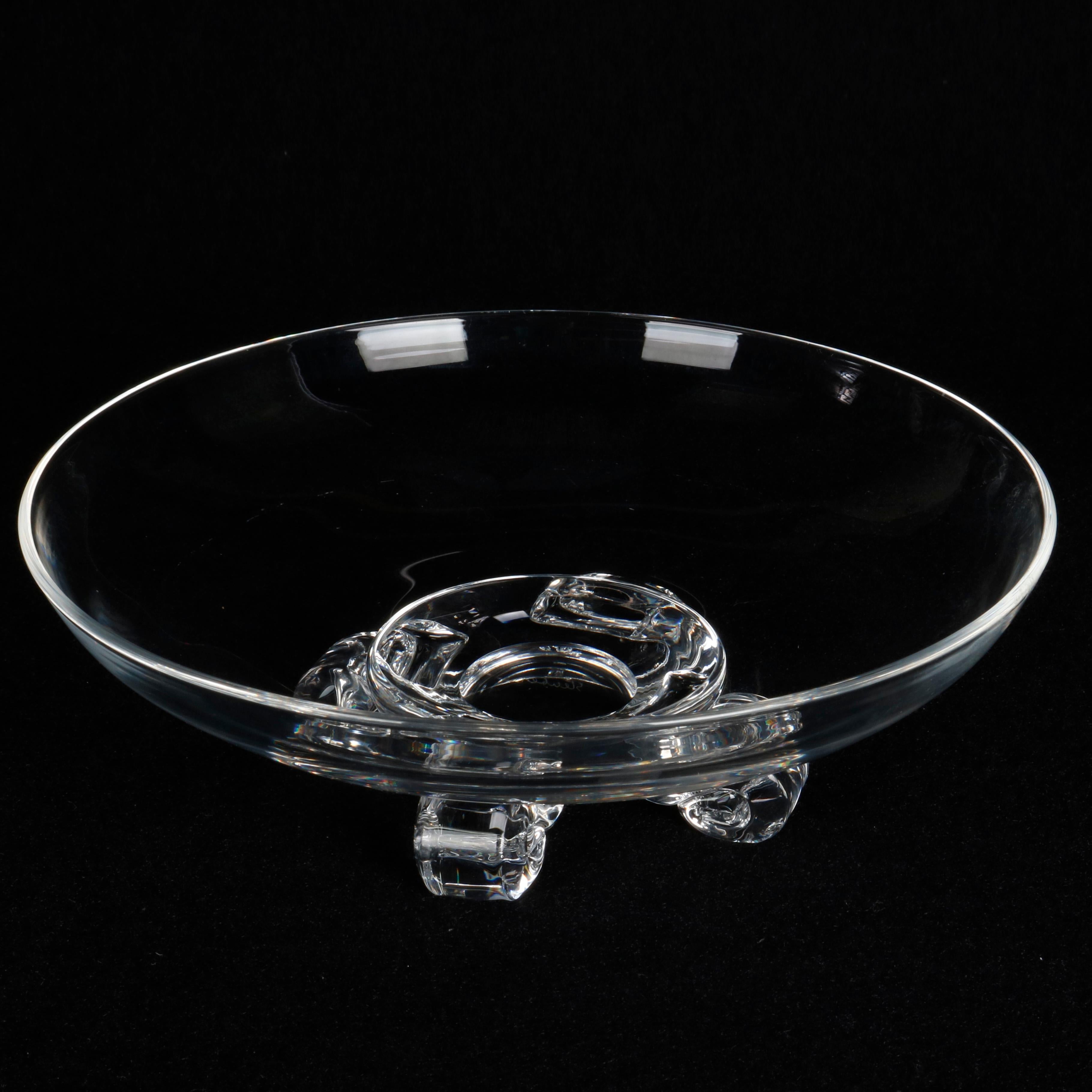 A crystal center bowl by Steuben Glass works offers low form raised on scroll form feet, signed on base as photographed, 20th century
 

Measures: 2.75