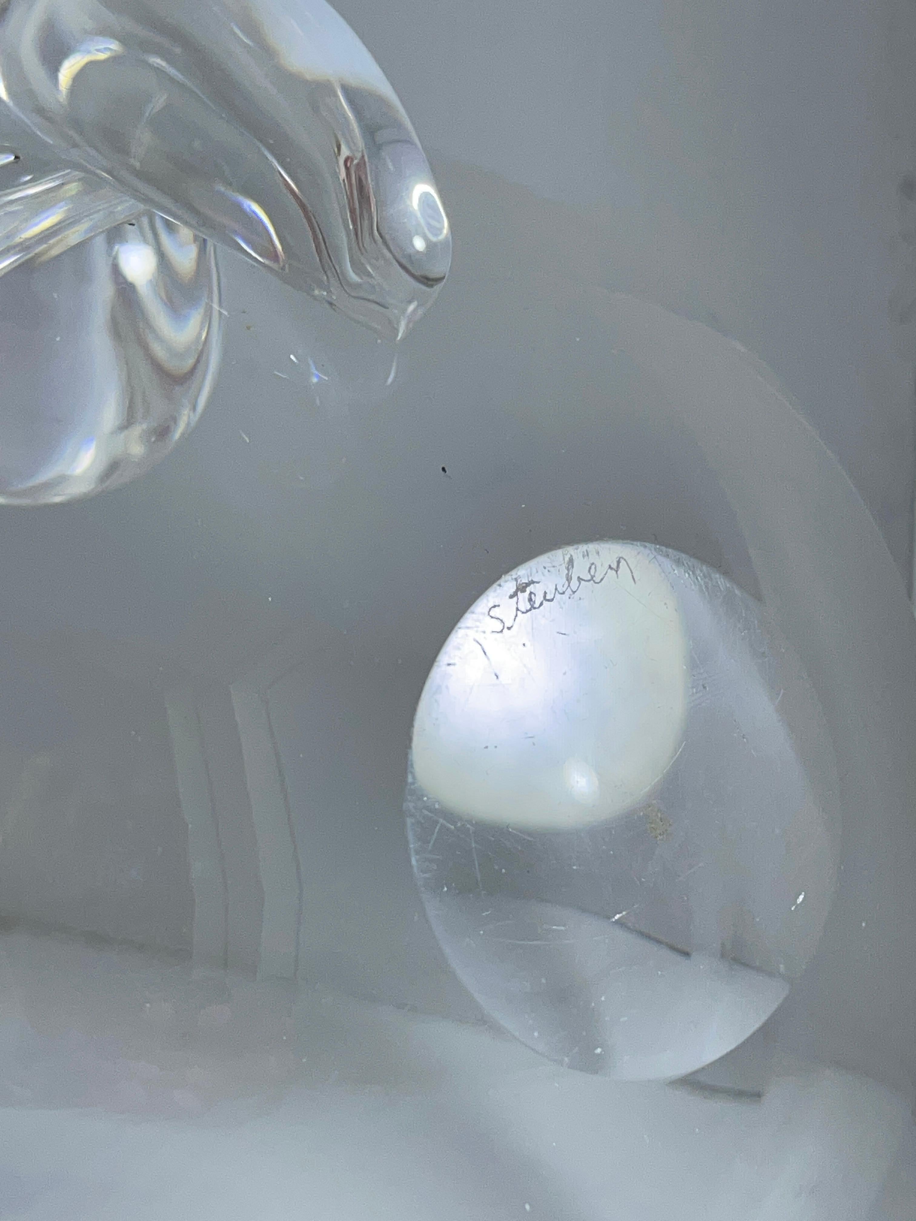 Steuben clear lead crystal Olive dish designed by John Dreves.

Produced by Steuben Glass Works and first introduced at the 1939 World's Fair, this iconic bowl features the fluid scrolled glass bit handle that characterizes mid-century Steuben