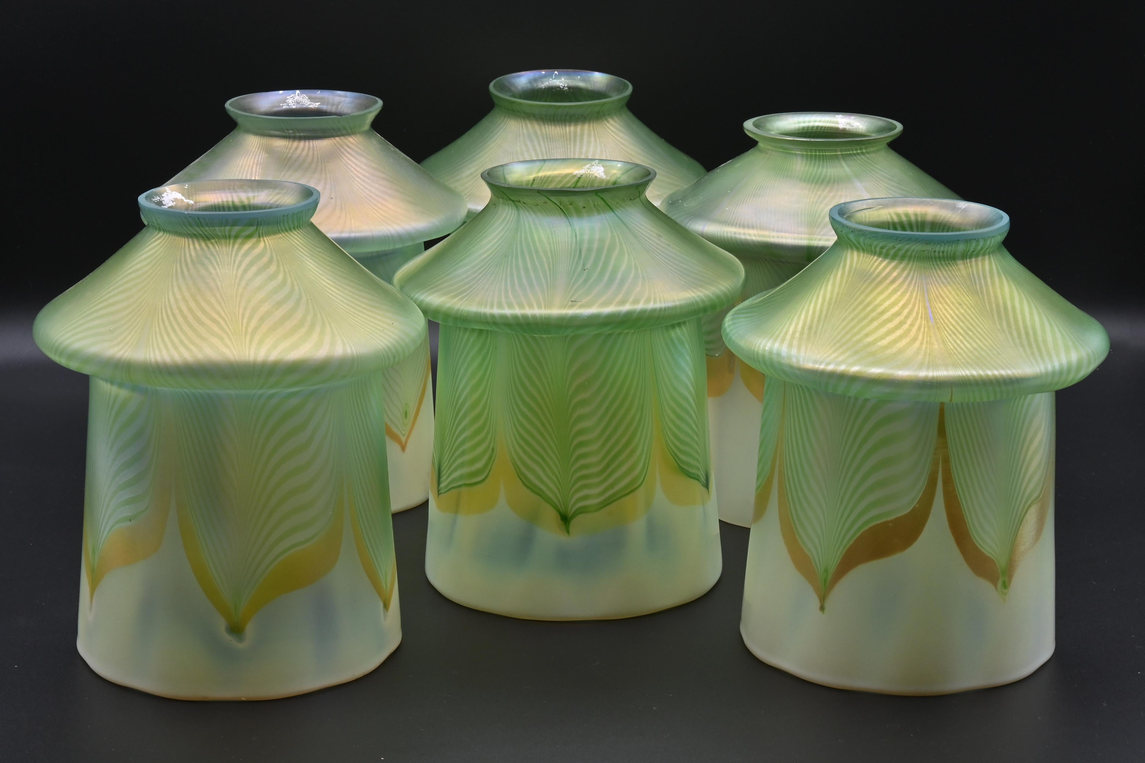 Steuben iridescent green & gold pulled feather 
Pattern 2327 from Carder Catalog 1905 

A special mix of glass that can’t be replicated today. 
Each shade was hand blown by up to six skilled artisans per shade.

Sold Individually 
6