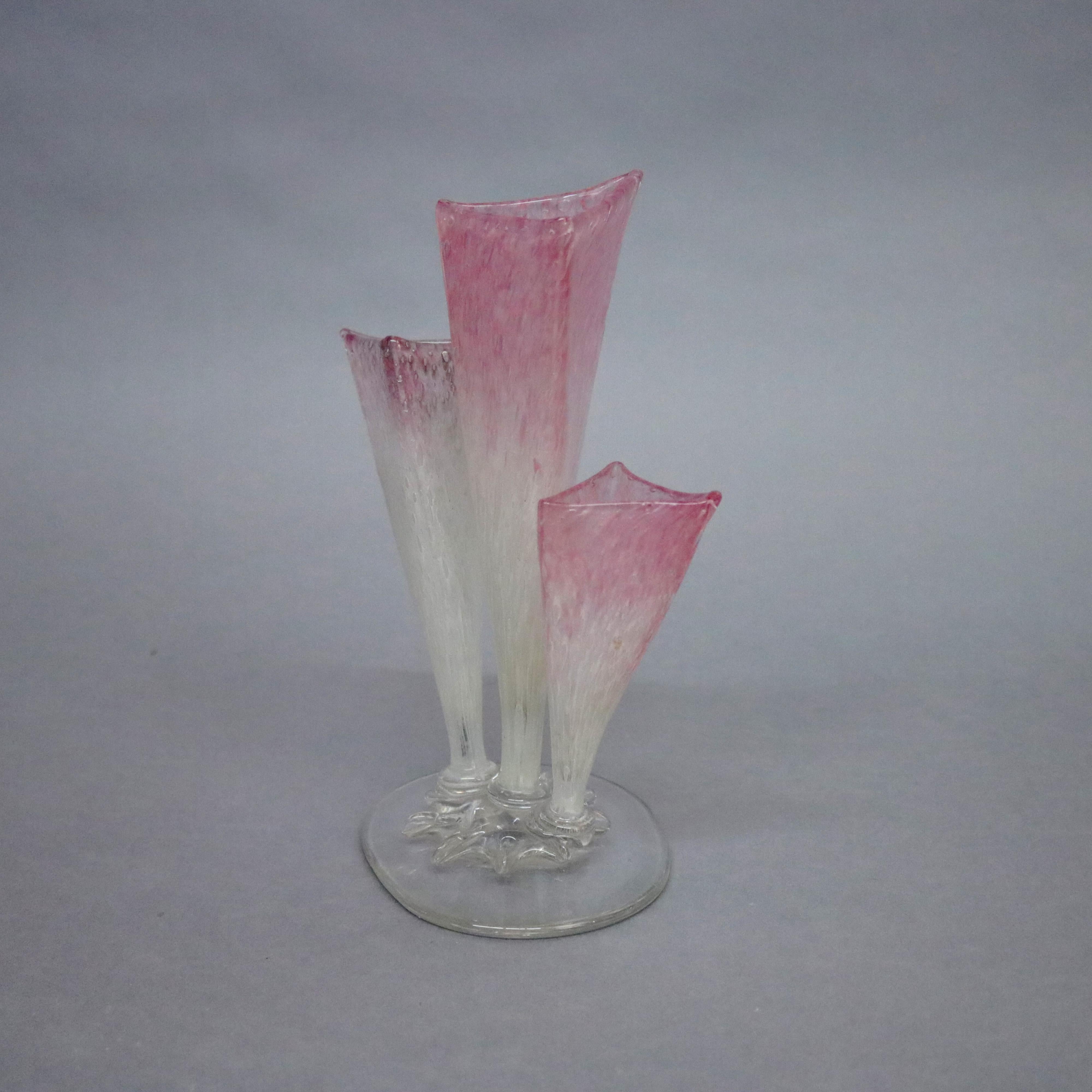 Steuben three prong stump vase features Rosaline into Alabaster Clutha bowls in pyramidal form surmounting crystal base, acid stamp signed, circa 1930.

Measures: 9.5