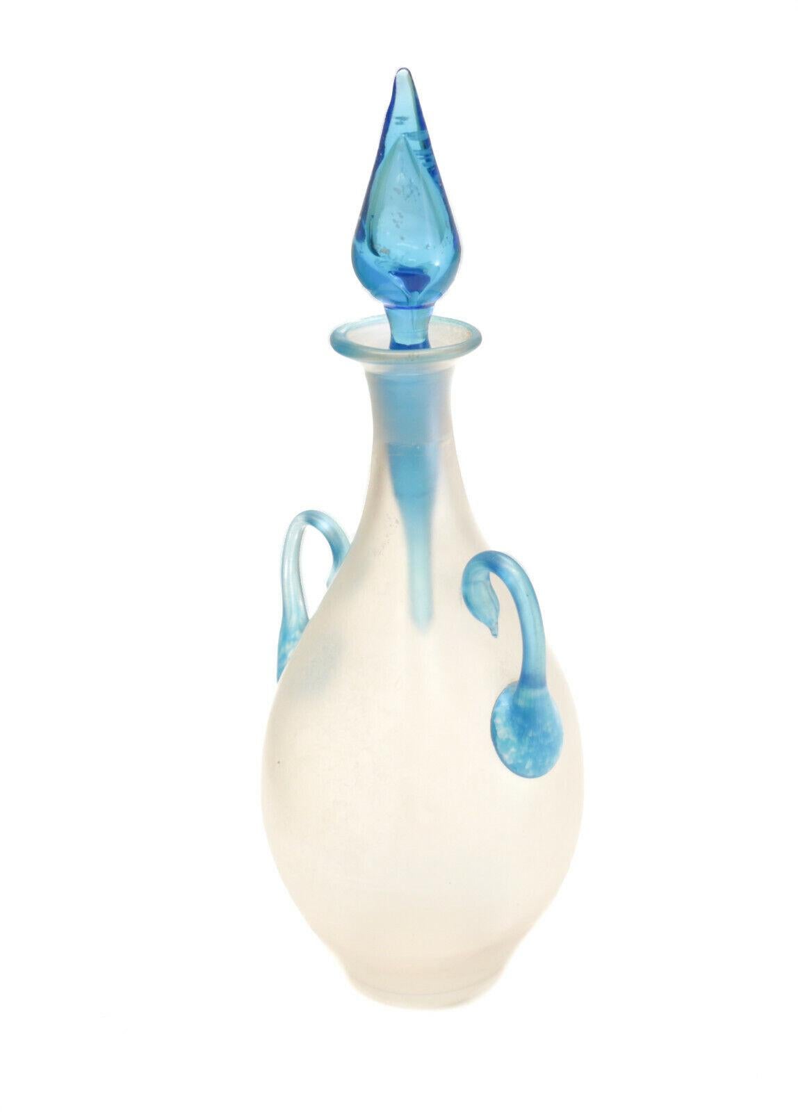 Steuben Silk Glass Perfume Bottle with Handles & Celeste Blue Stopper #3048

Celeste blue handles, lip, and long rod stopper. Unmarked, but a known Steuben piece. 

Additional information:
Pattern: Silk Glass
Type: Perfume Bottle 
Color: