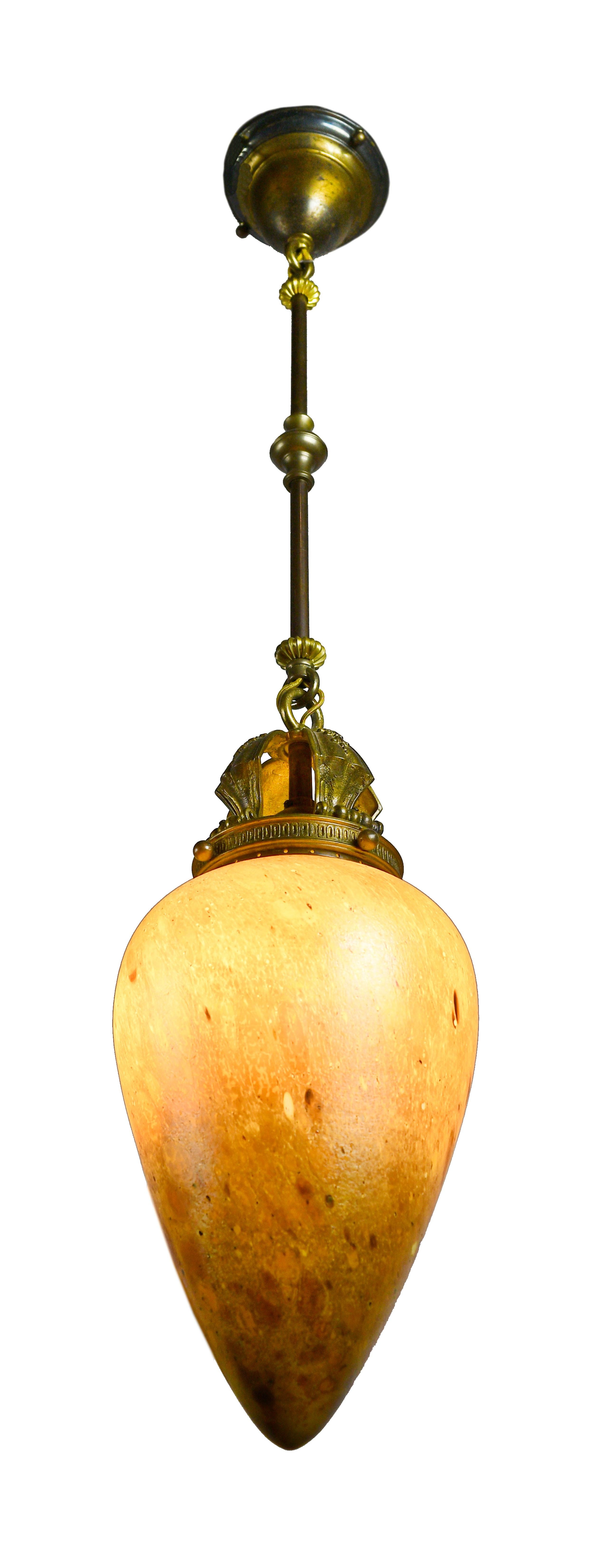 This finely crafted pendant features intricate detailing and an absolutely stunning Steuben shade that gives off a warm orange glow when illuminated.
Steuben Glass works was founded in 1903 by Frederick Carder, who has honed his craft in England.