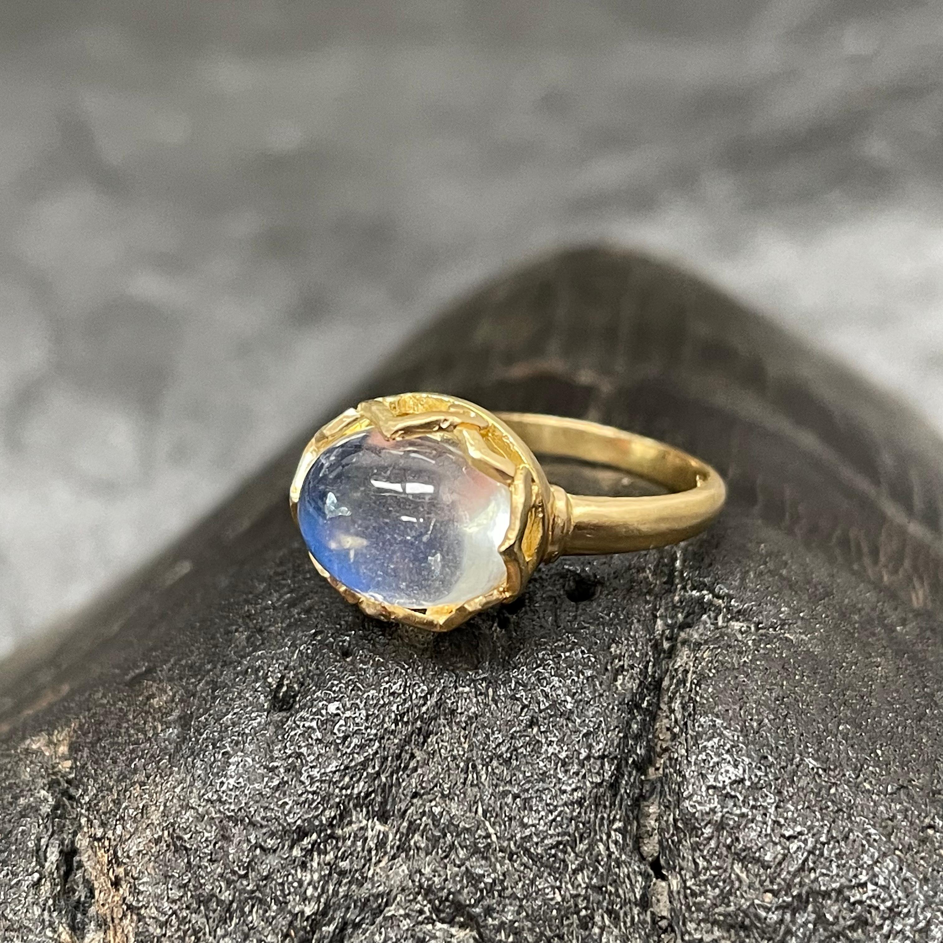 A shimmering 8 x10 mm rainbow moonstone is held in an airy embrace amid a carved lattice design bezel and plain matte-finish tapered shank.
You can't go wrong with this beautiful stone. A delicate and eye-catching design!  This ring is currently