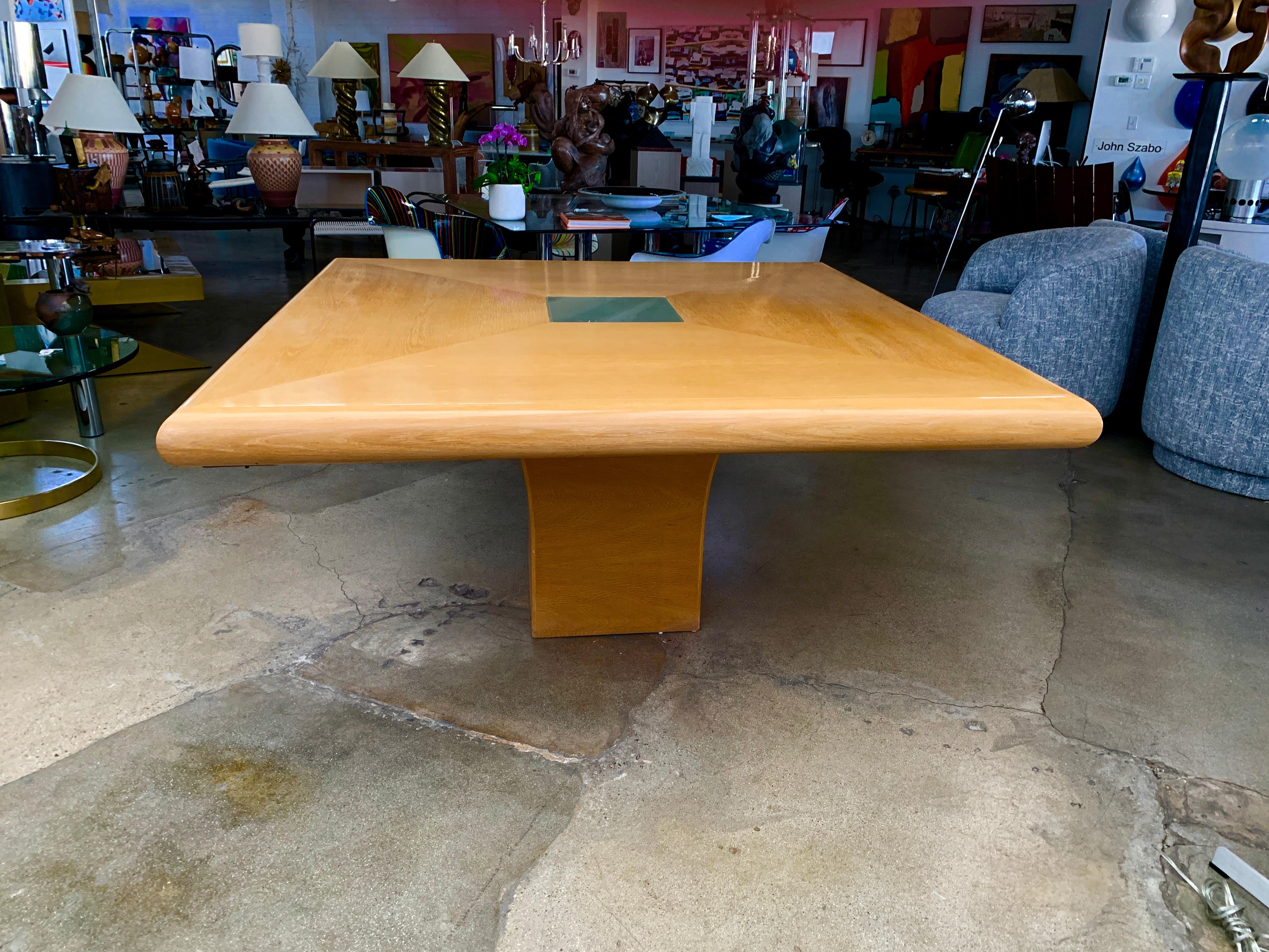 A Steve Chase/Arthur Elrod designed custom dining table made by Philip Sicola of Culver City California. This oak veneered table feature a center frosted glass plate which is illuminated from below when lit. It seats eight comfortable and we have