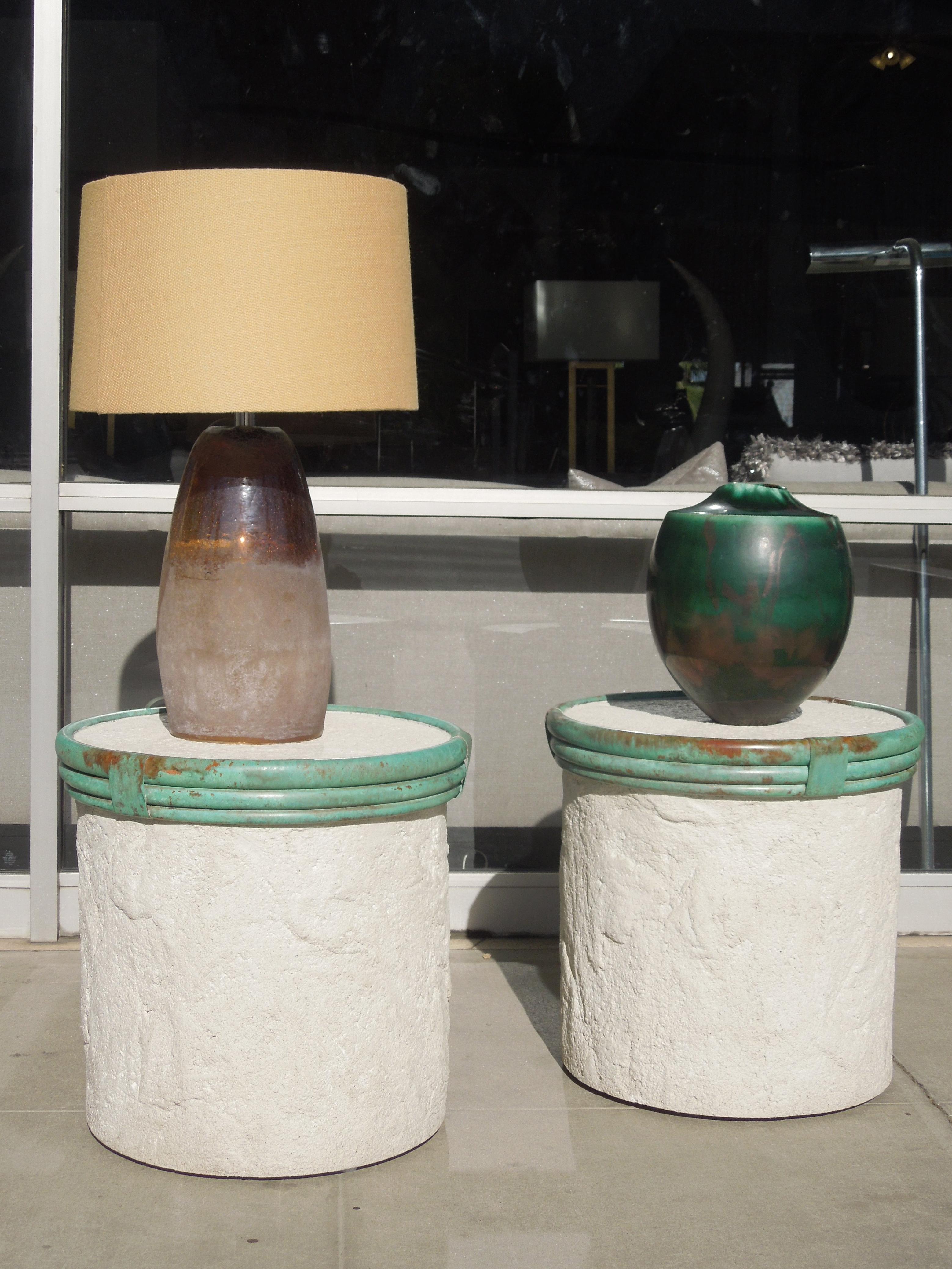 This pair of plaster (over wood) and polished metal verdigris trim cylinder tables are very much in the style of the great Michael Taylor. They are beautifully made and from a vintage Palm Springs Estate that was designed by the legendary Steve