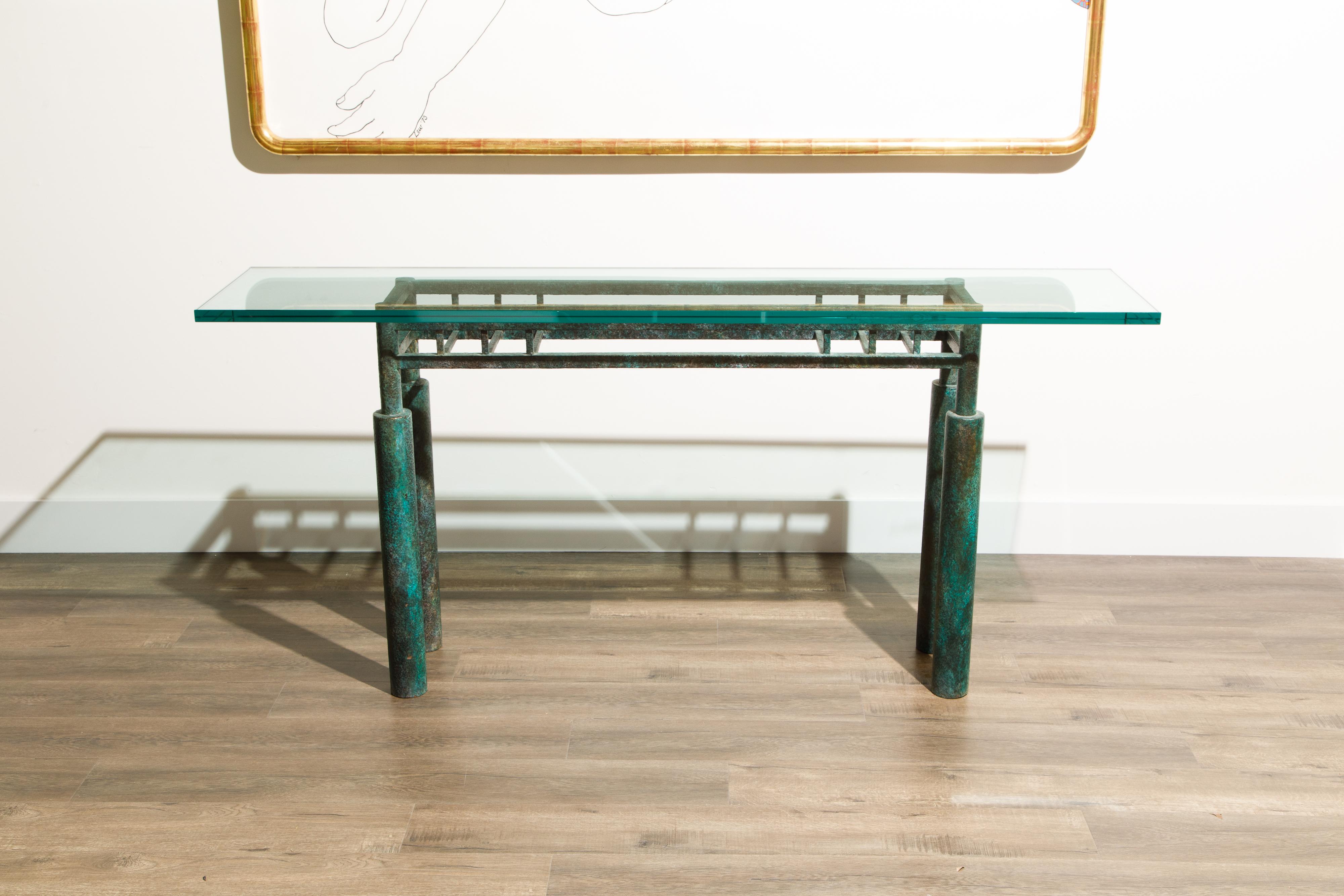This Post-Modern brutalist console table by Steve Chase features a blueish green patinated steel frame with thick glass top. For fans of the movie 'Beetlejuice' - this piece looks like it belongs right on the set of the main house after it was
