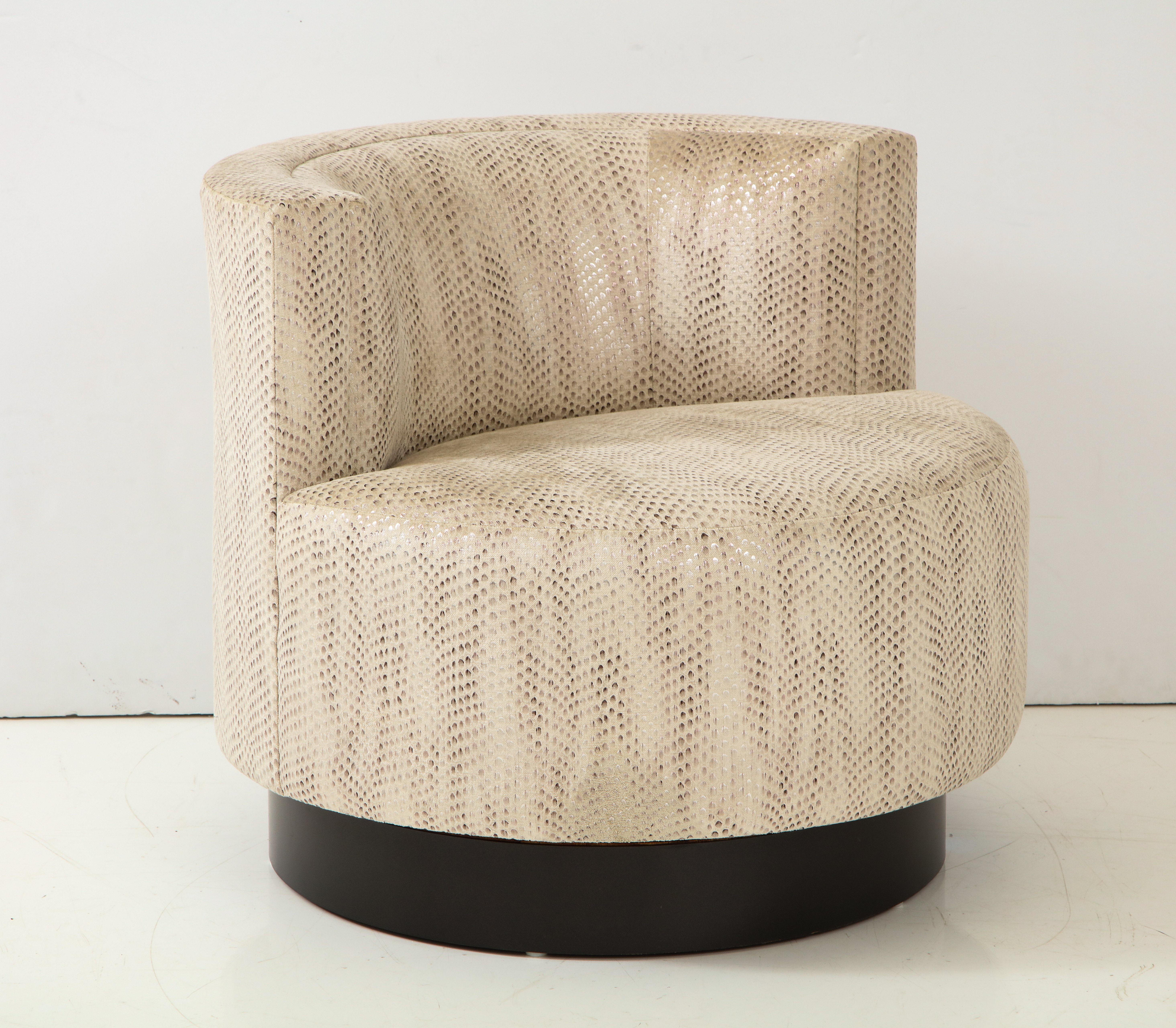 Elegant swivel chair designed by Steve Chase.
The chair has been newly reupholstered in a Luxurious snakeskin foil print fabric
by Zinc Textiles.