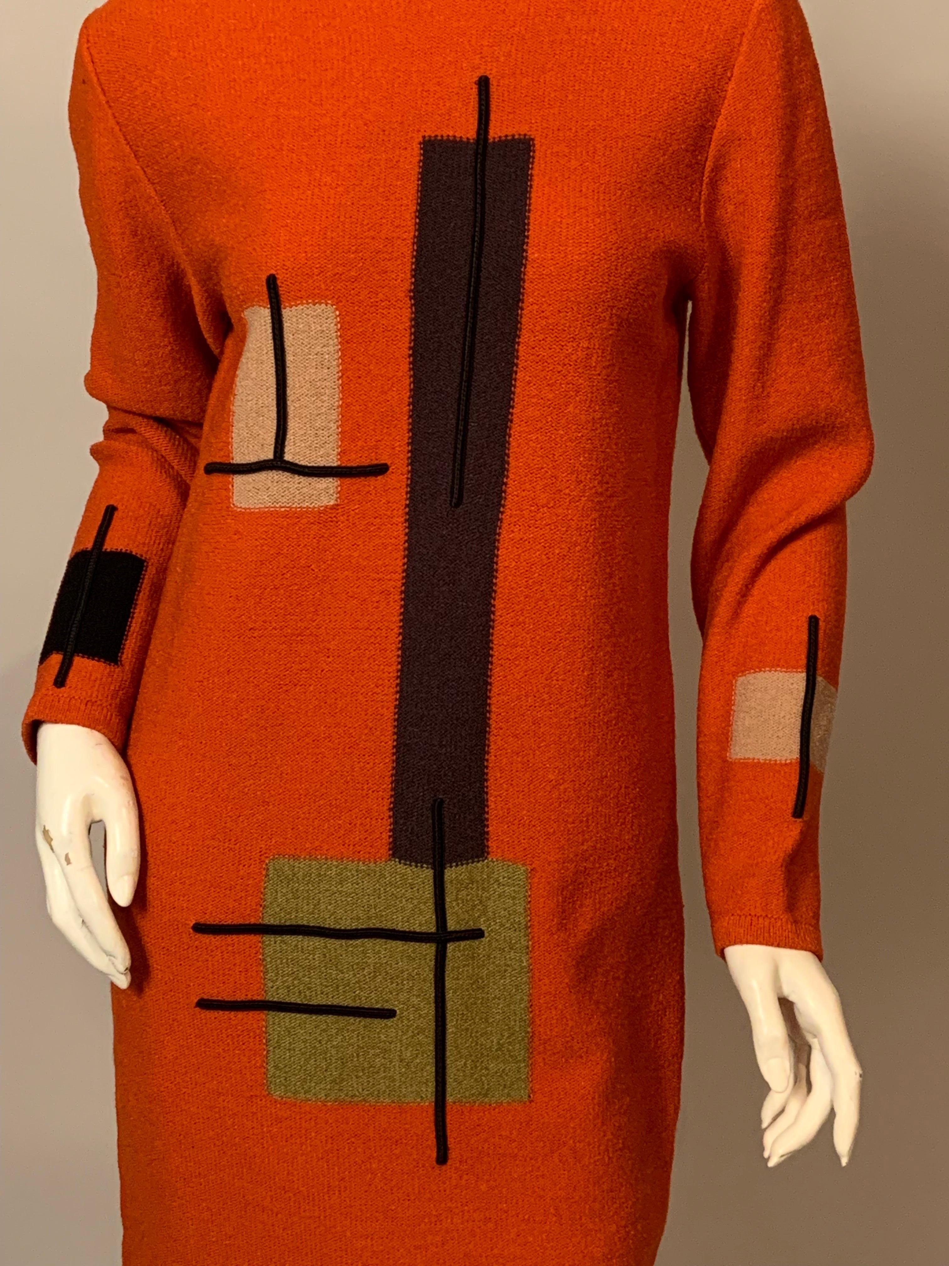 This sleek orange knit dress designed by Steve Fabrikant has a wonderful Modernist inspired design on the front and the sleeves.  The geometric design is done in camel, olive and charcoal grey yarn with bars of black braid adding dimension and