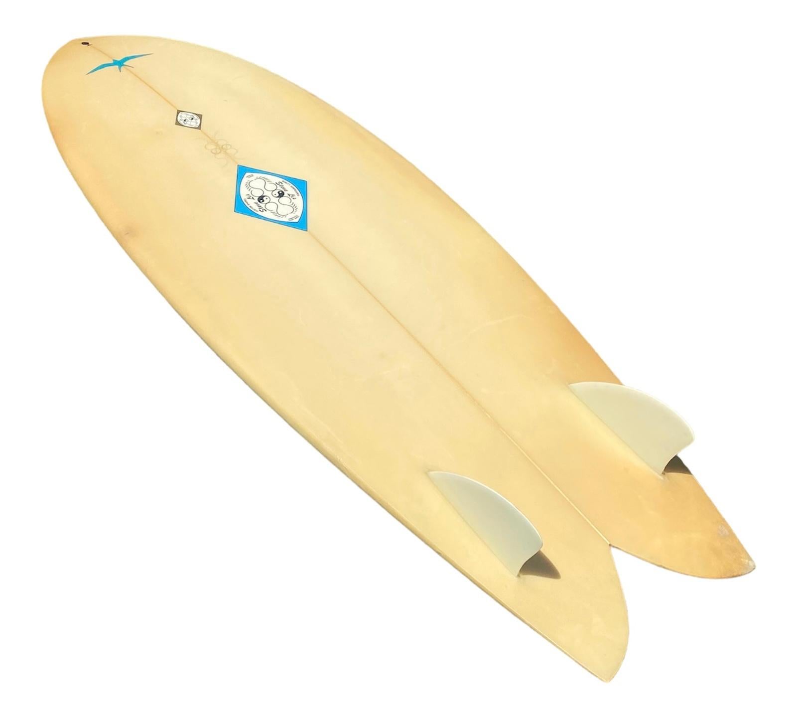 Steve Lis ‘Flaming’ Fish surfboard. Features the revolutionary fish shape which Steve Lis invented in the 1960s. Beautiful airbrush yellow-green fade with flames and glassed on twin-fins. Hand drawn yin and yang symbols written by Steve Lis on both