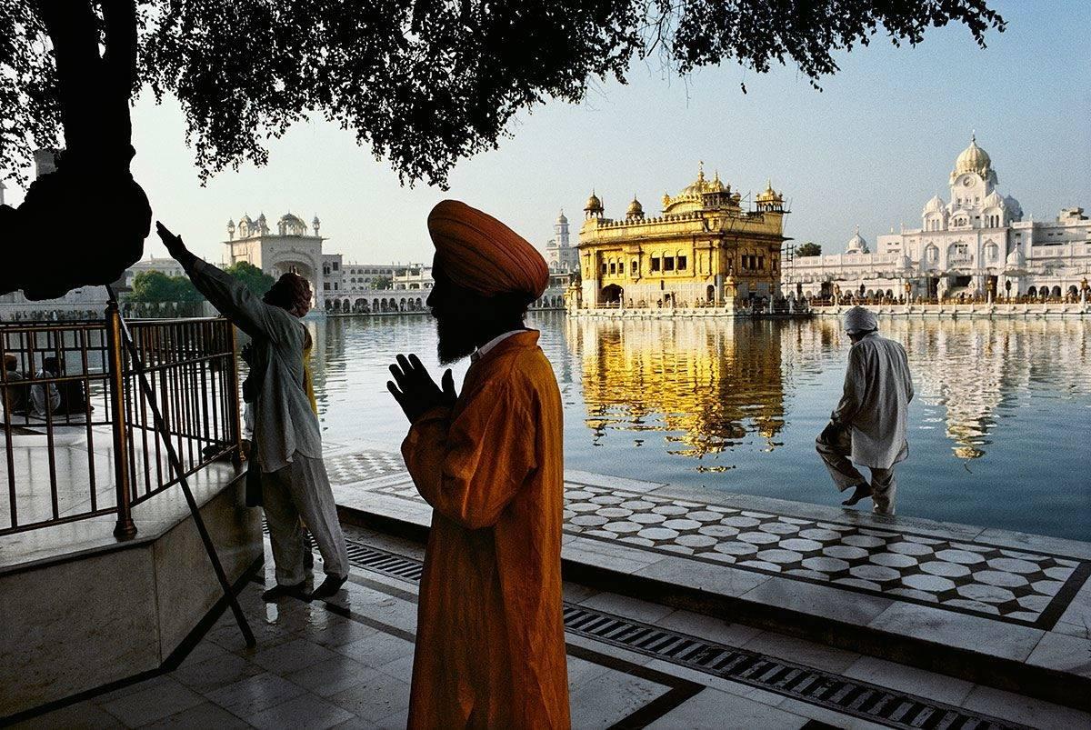 Steve McCurry Landscape Photograph - Sikh devotee prays at the Golden Temple, Amritsar, Punjab, India