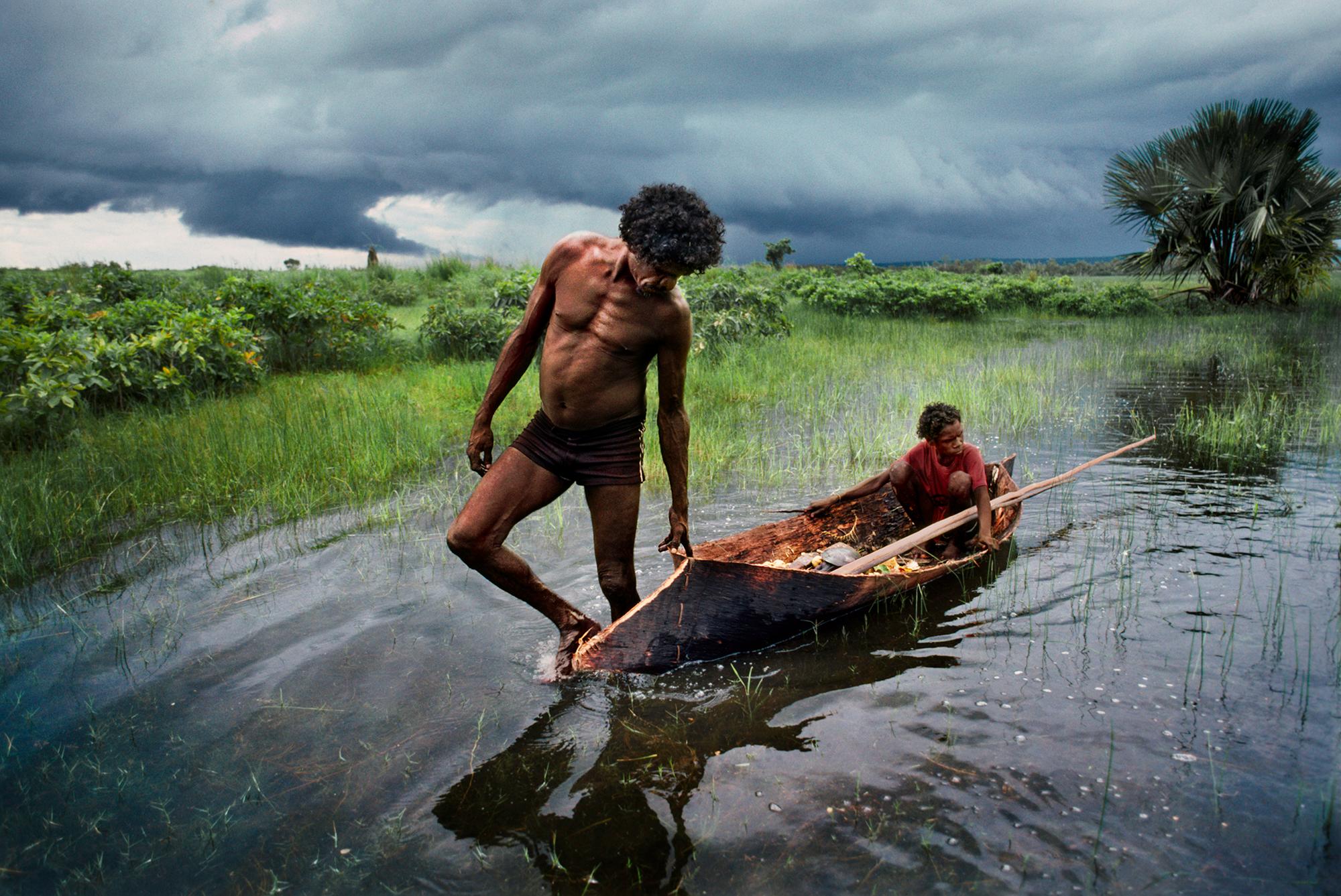 Steve McCurry Color Photograph - Father and Son Hunt in a Canoe, Northern Territory, Australia, 1984 