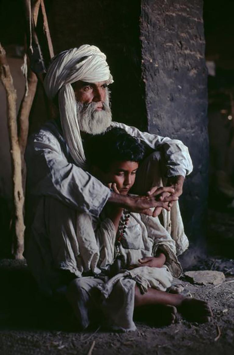 Father and Son in Helmand Province, Afghanistan, 1980 - Steve McCurry 
Signed and numbered on photographer’s edition label on reverse
Digital c-type print

24 x 20 inches 
30 x 40 inches 
40 x 60 inches 

Steve McCurry (born 1950) is best known for