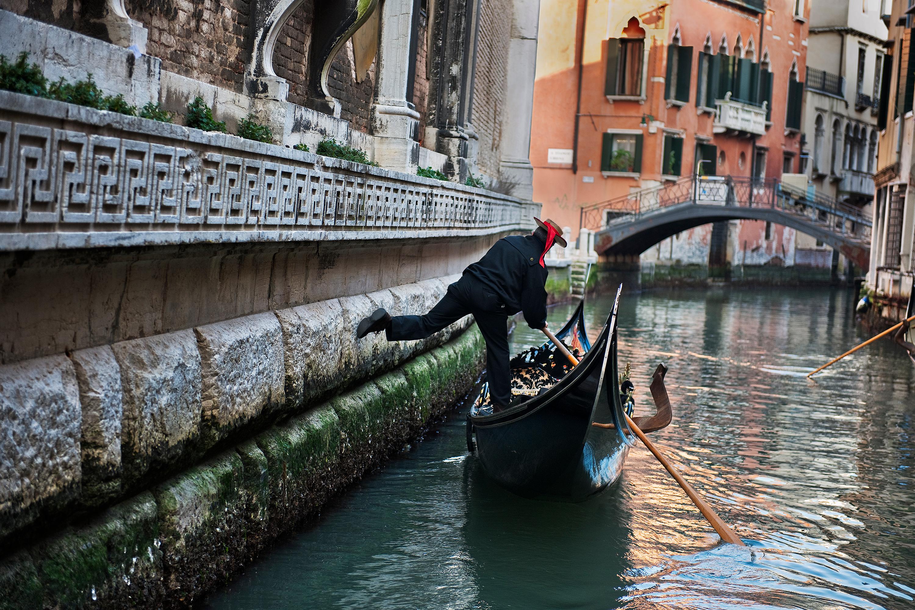 Gondolier on Canal  - Photograph by Steve McCurry