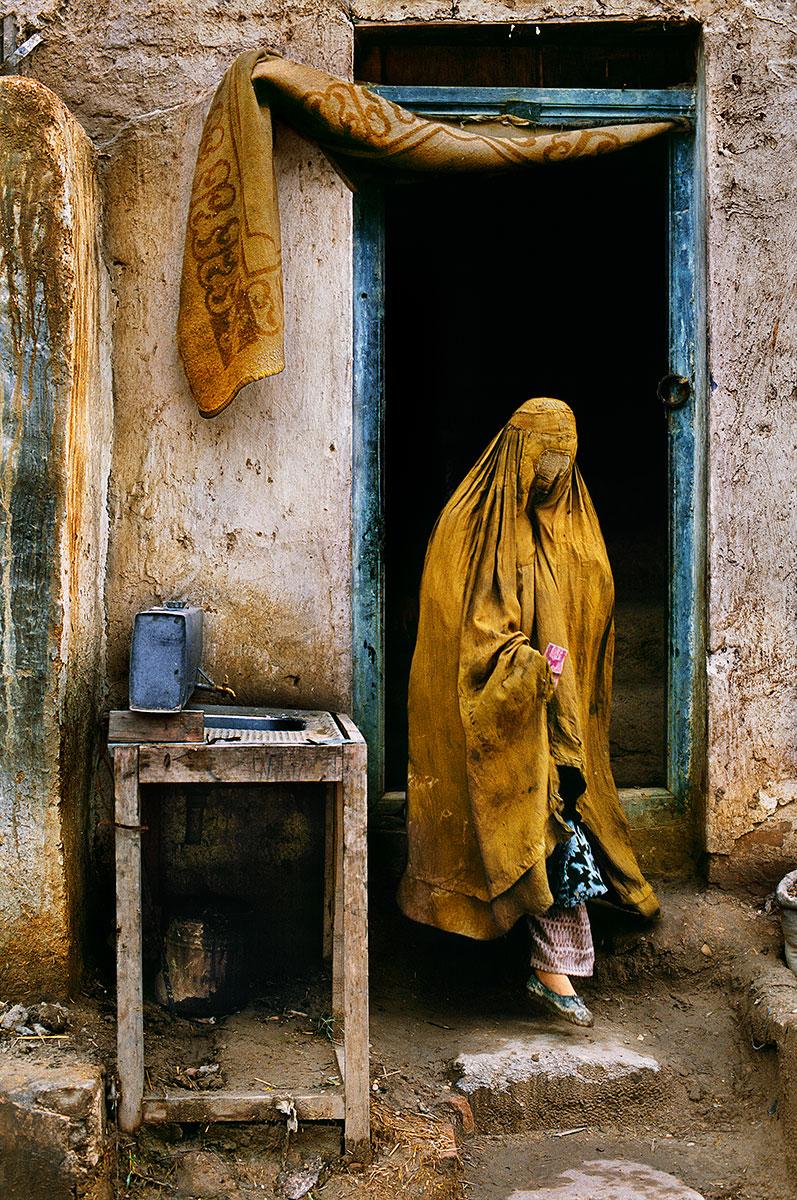 Widow Exits Restaurant by Steve McCurry is listed as a 20 x 24 inch digital c-print, available in an edition of 30. This photograph is printed on FujiFlex Crystal Archive Supergloss Paper. It is signed on print verso by Steve McCurry, and inscribed