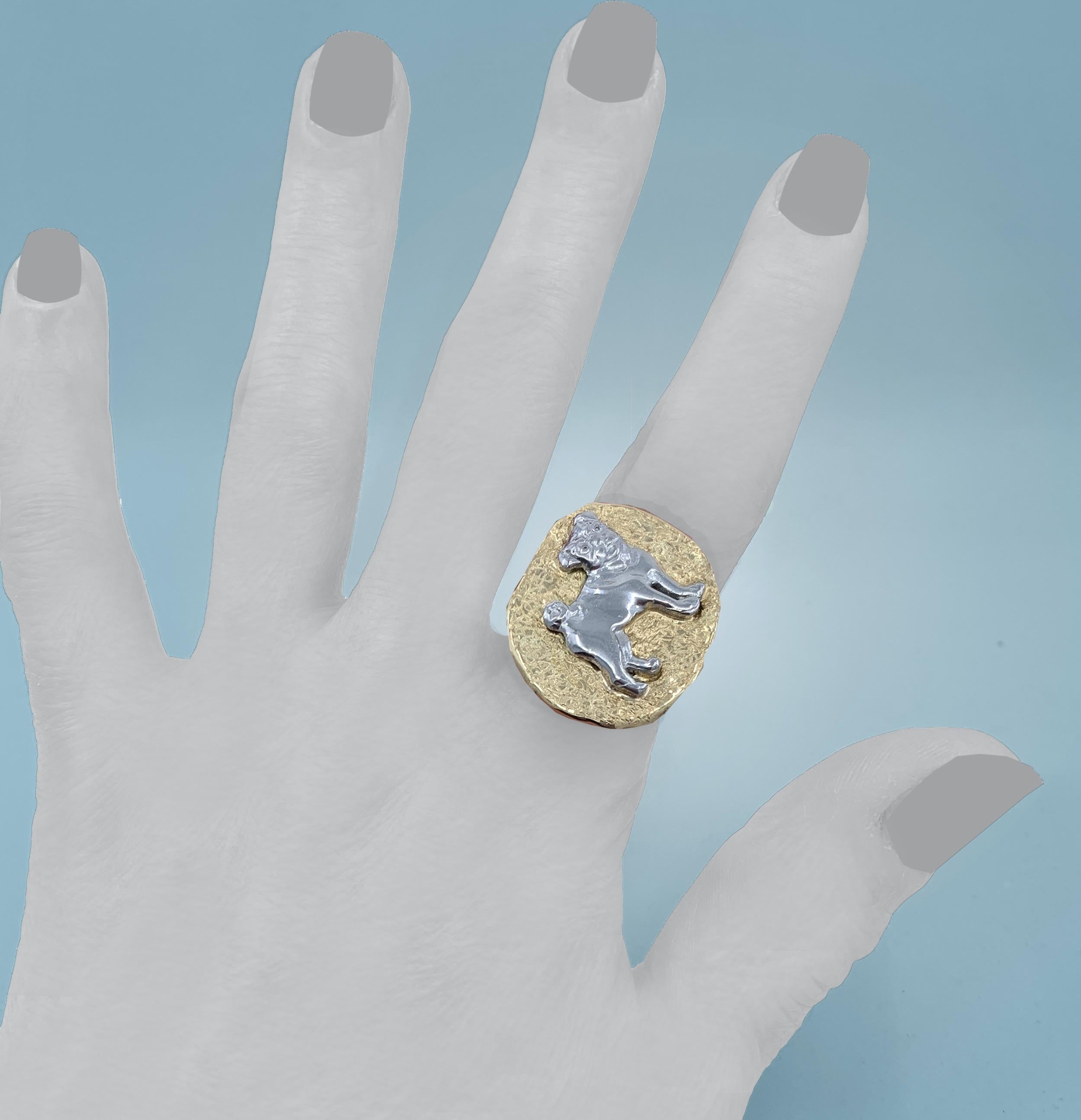 This adorable, one-of-a-kind ring by Eytan Brandes is an homage to Eytan's favorite pug.  

The 18 karat gold mounting is high polish on the sides and back, but the not-quite-symmetrical oval face of the ring has a cool 