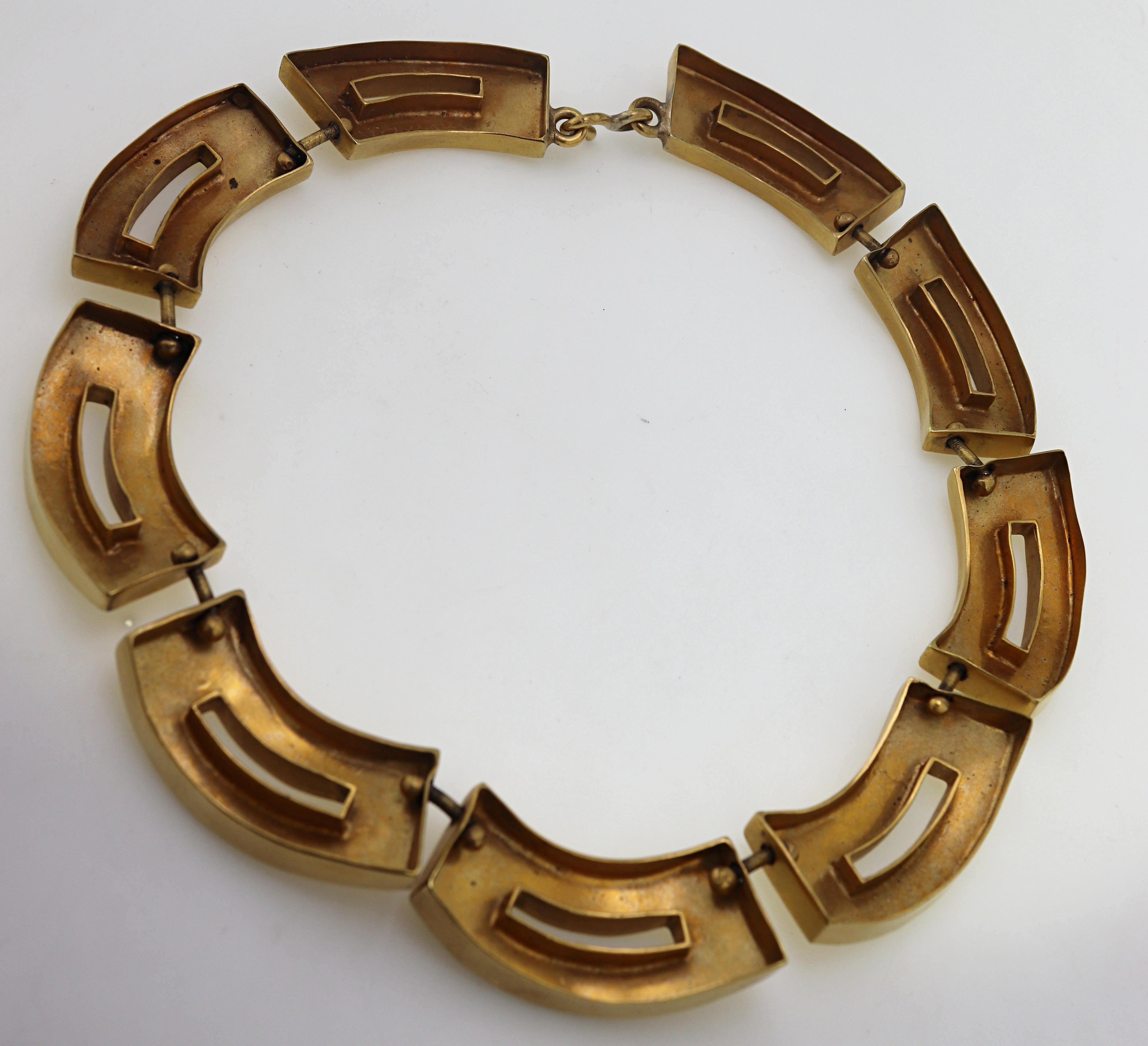 Composed of nine bold modern geometric links, 46.5 X 19.2 X 5.5 mm,
completed by a hook clasp, forming a 16 inch necklace, signed Vaubel.