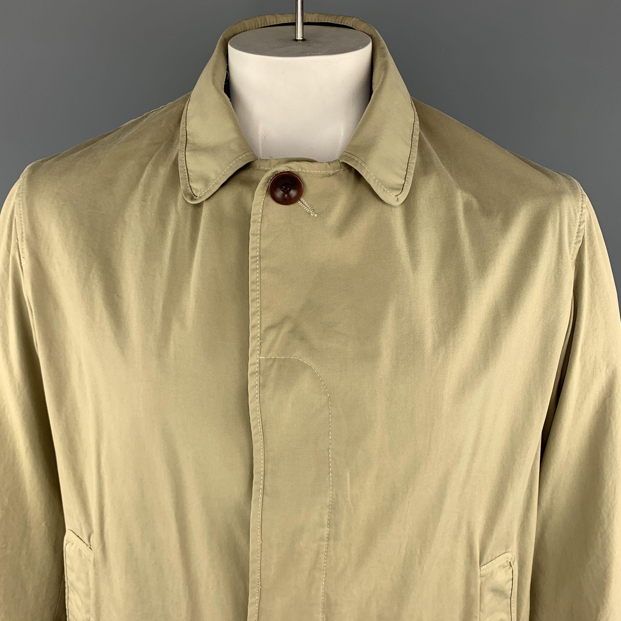 STEVEN ALAN Coat comes in a khaki tone in a solid cotton material, with five buttons at closure, single breasted, slit pockets, unbuttoned cuffs, a double vent at back, and a plaid patchwork lining. Made in USA.
 
Excellent Pre-Owned