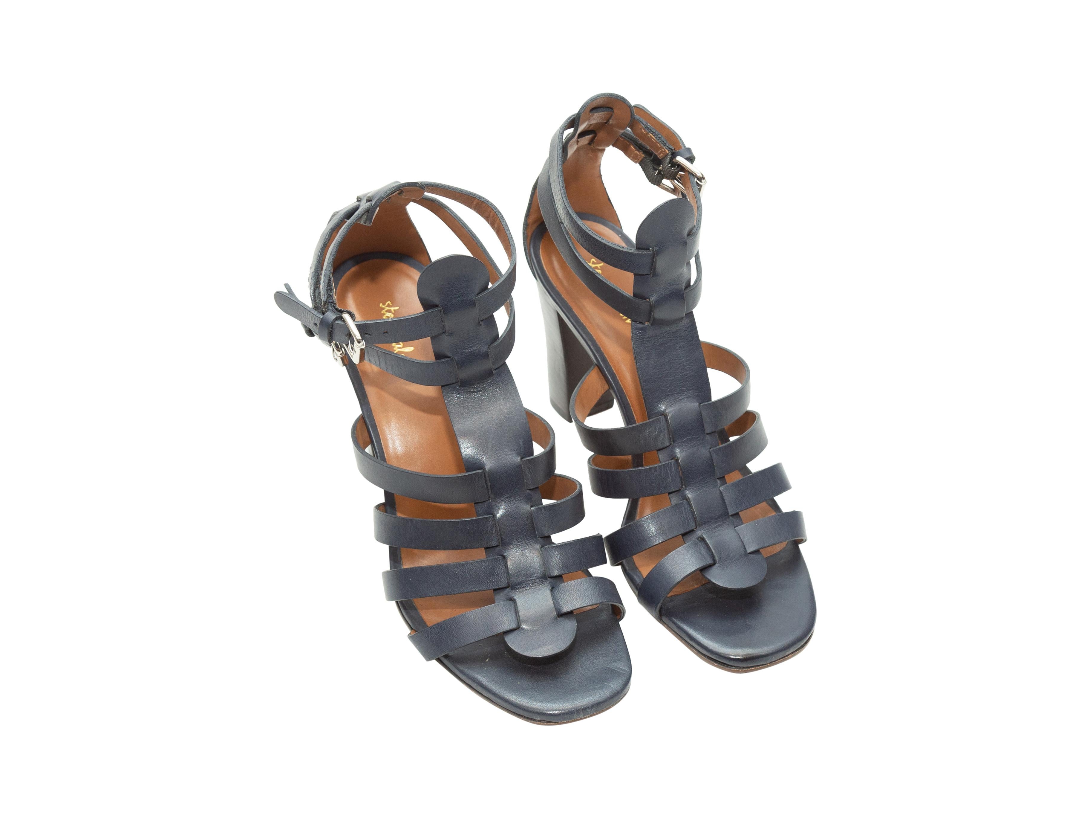 Product details: Navy leather cage heeled sandals by Steven Allen. Stacked heels. Dual buckle closures at ankles. 3.5