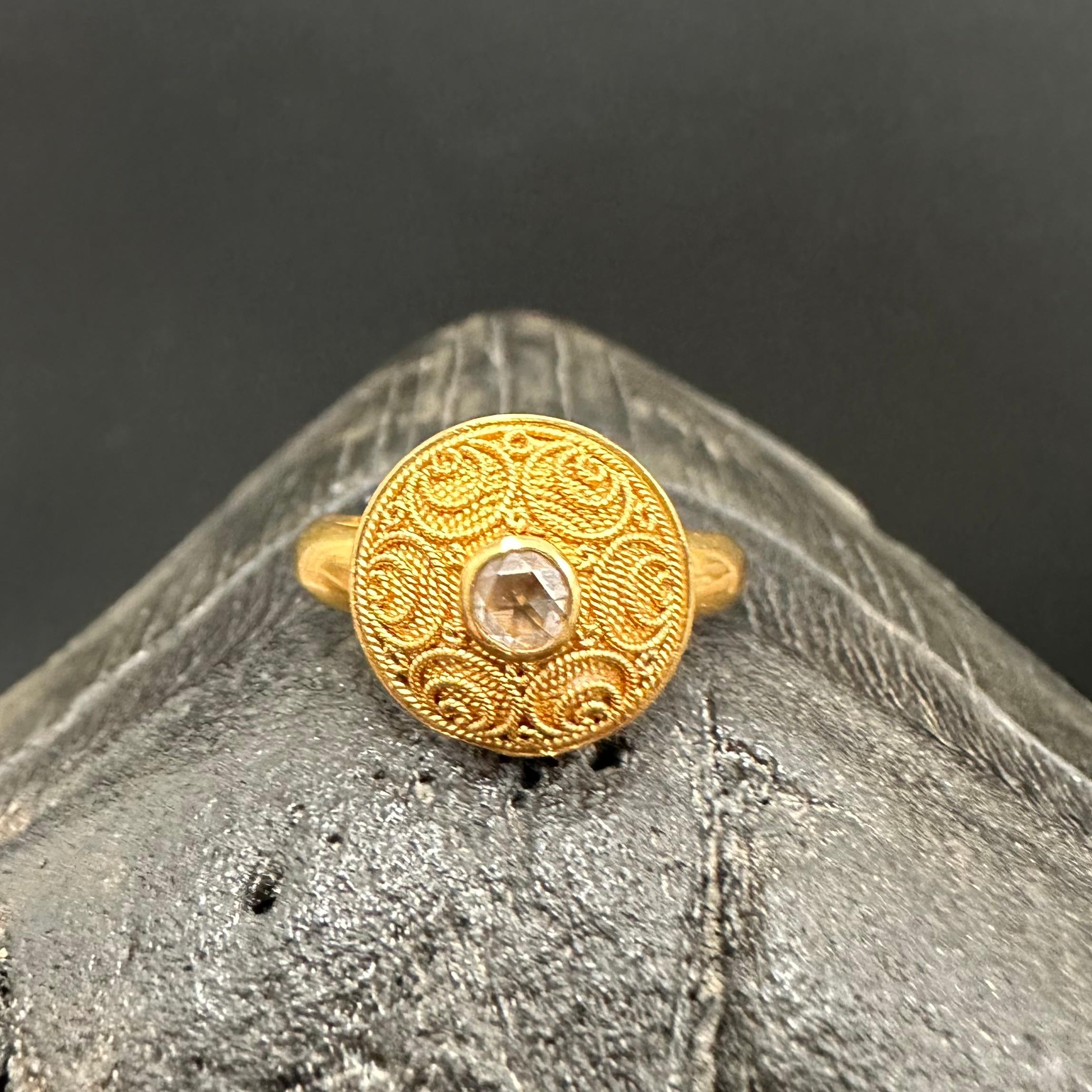A 4 mm rose-cut white faceted VS1 diamond rests in the center of an incredibly intricate handcrafted small 22K gold twist wire design consisting of multiple circles in a rosette pattern atop a slightly domed background of similar concentric twist