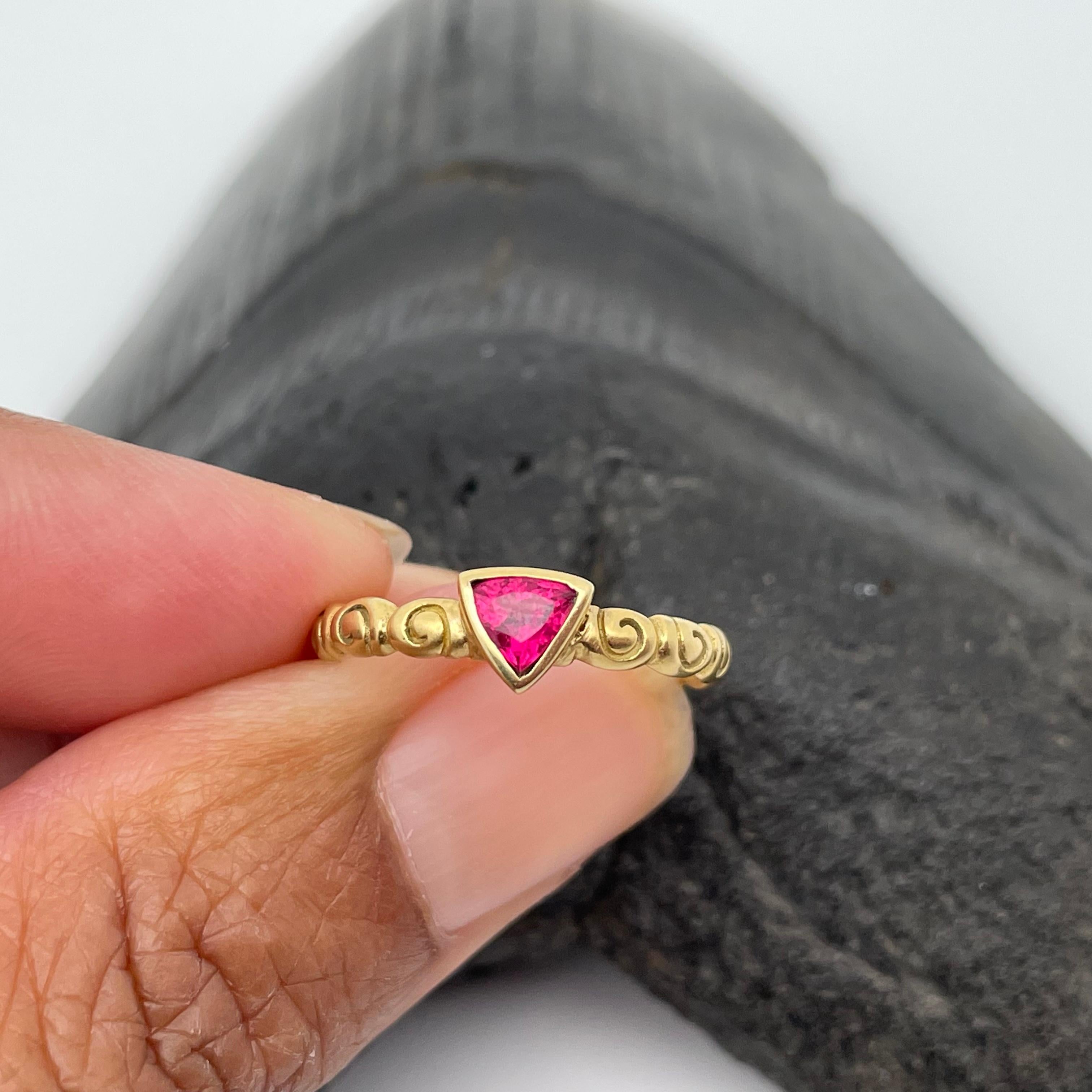 A brilliant 4 mm trillium faceted rubelite pink tourmaline rests in the center of gentle matte-finish spirals in this elegant design.  This ring is sized 6.
It is easily resizable.  Yummy!
