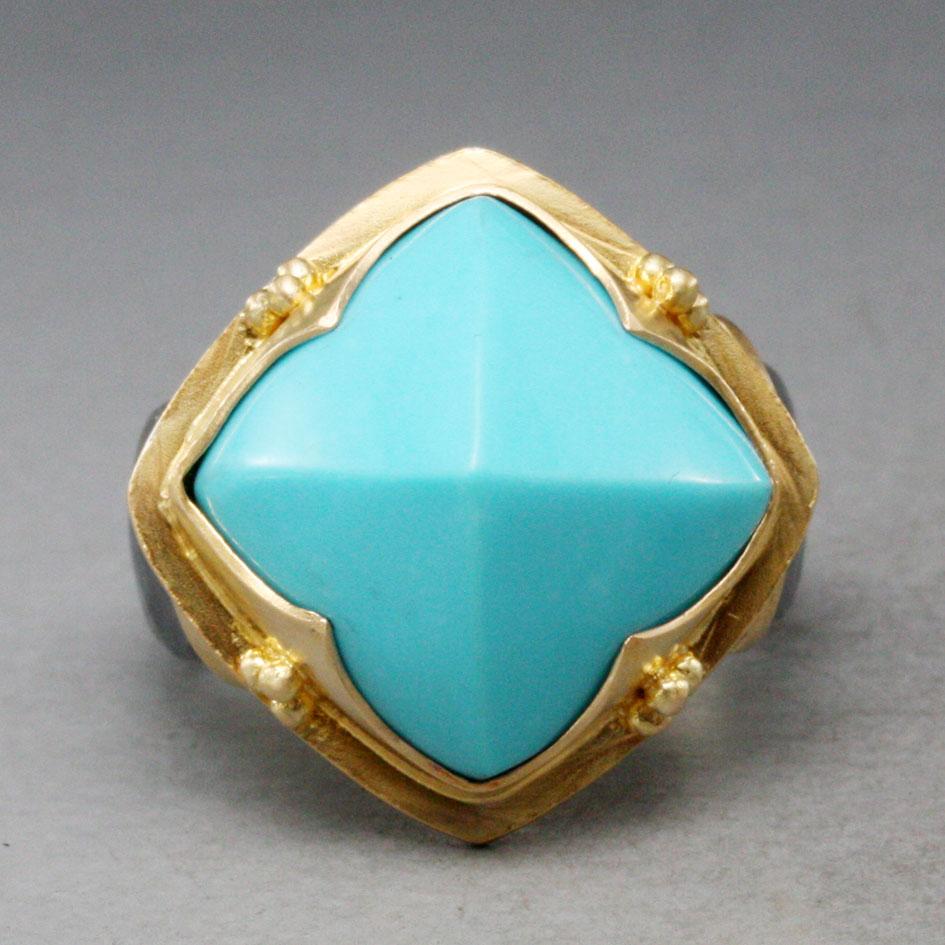 A beautiful and clean curved 14 mm pyramid shaped cabochon of  Sleeping Beauty Arizona turquoise is set diagonally in a 
