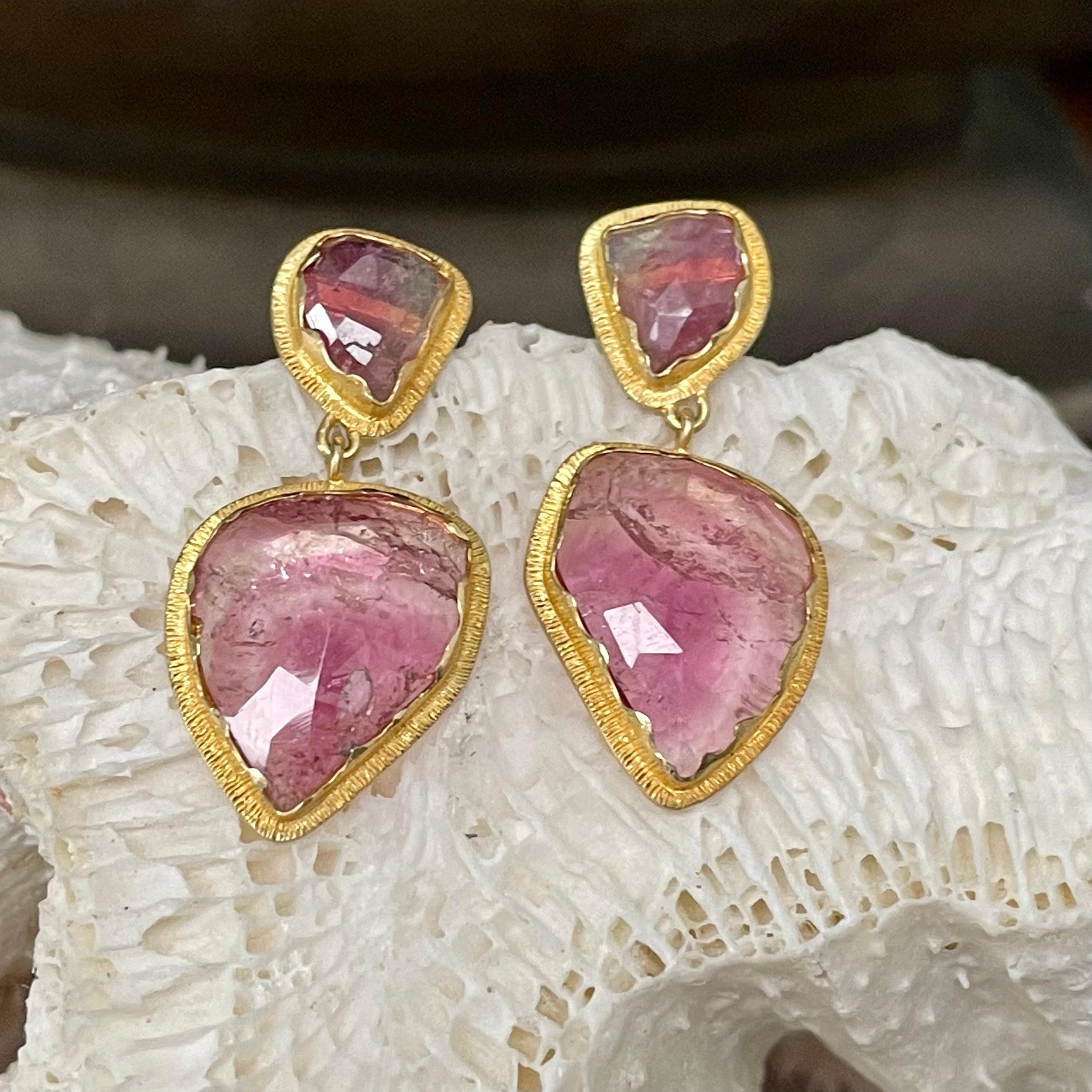 Organically shaped 12 x 16 mm variegated rose-cut watermelon tourmaline slices are set in scalloped 18K gold bezels with line texture surrounding  suspended below smaller similar posts in this one of a kind design.  Spectacular !