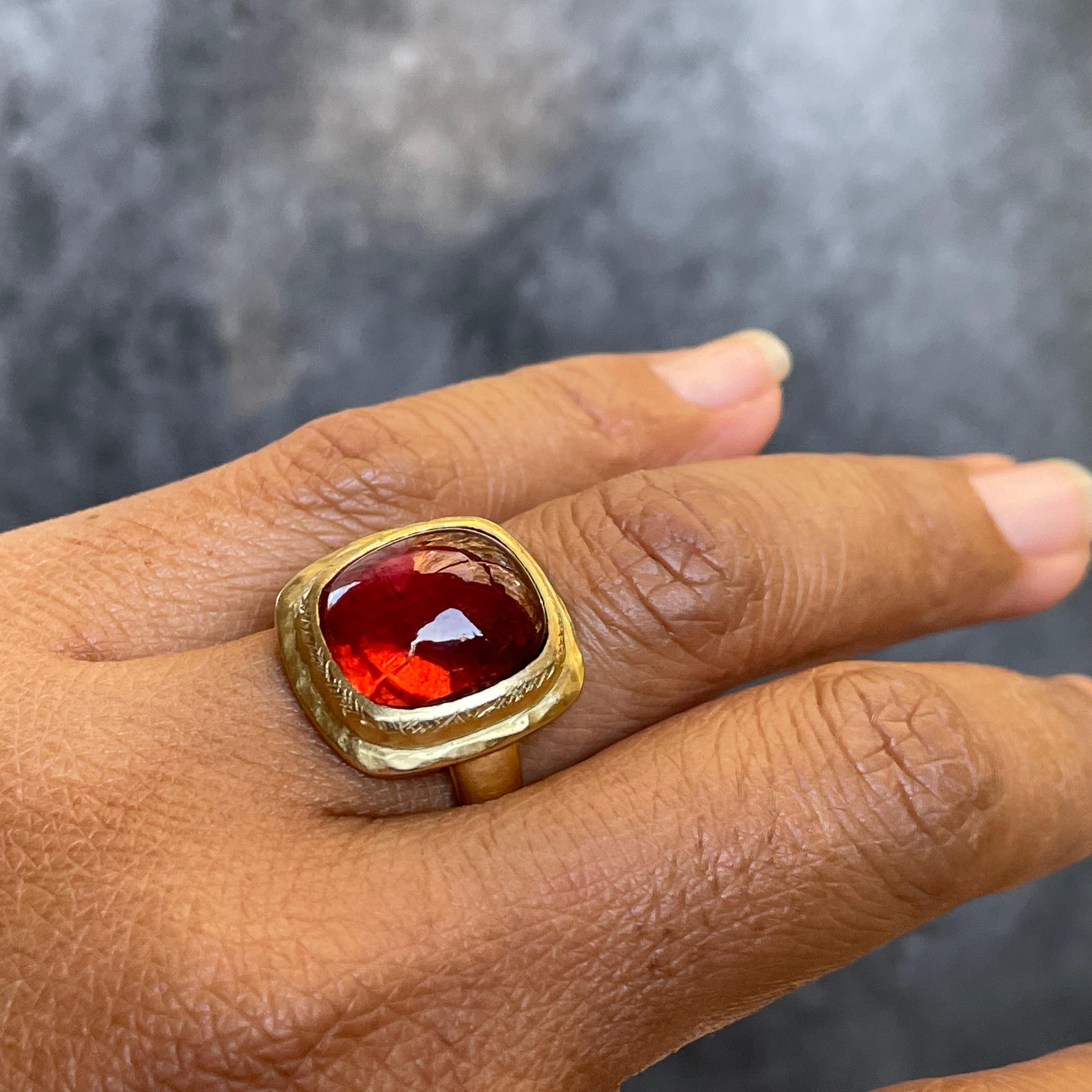 A beautiful VERY clear  12 x 14 mm cushion Tourmaline cabochon in an attractive reddish-pink shade is set surrounded by a stepped bezel with cross thatched accents on a comfortable tapered 18k band, all with matte-finish.  This is a really NICE