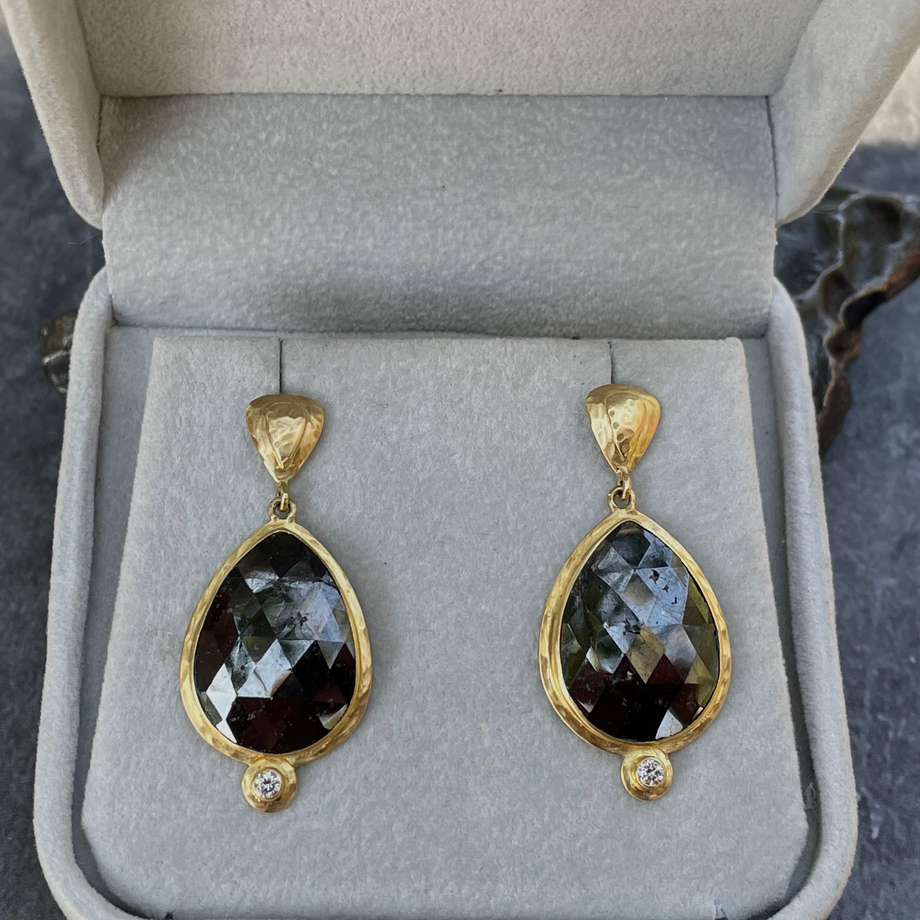 A matched pair of large 14 x 19 mm pear shaped rose cut black diamonds dangle below stepped and hammered posts with 1.8 mm VS1 white diamonds as bottom accents. Organic hammered bezels surround.  Elegant and a statement.