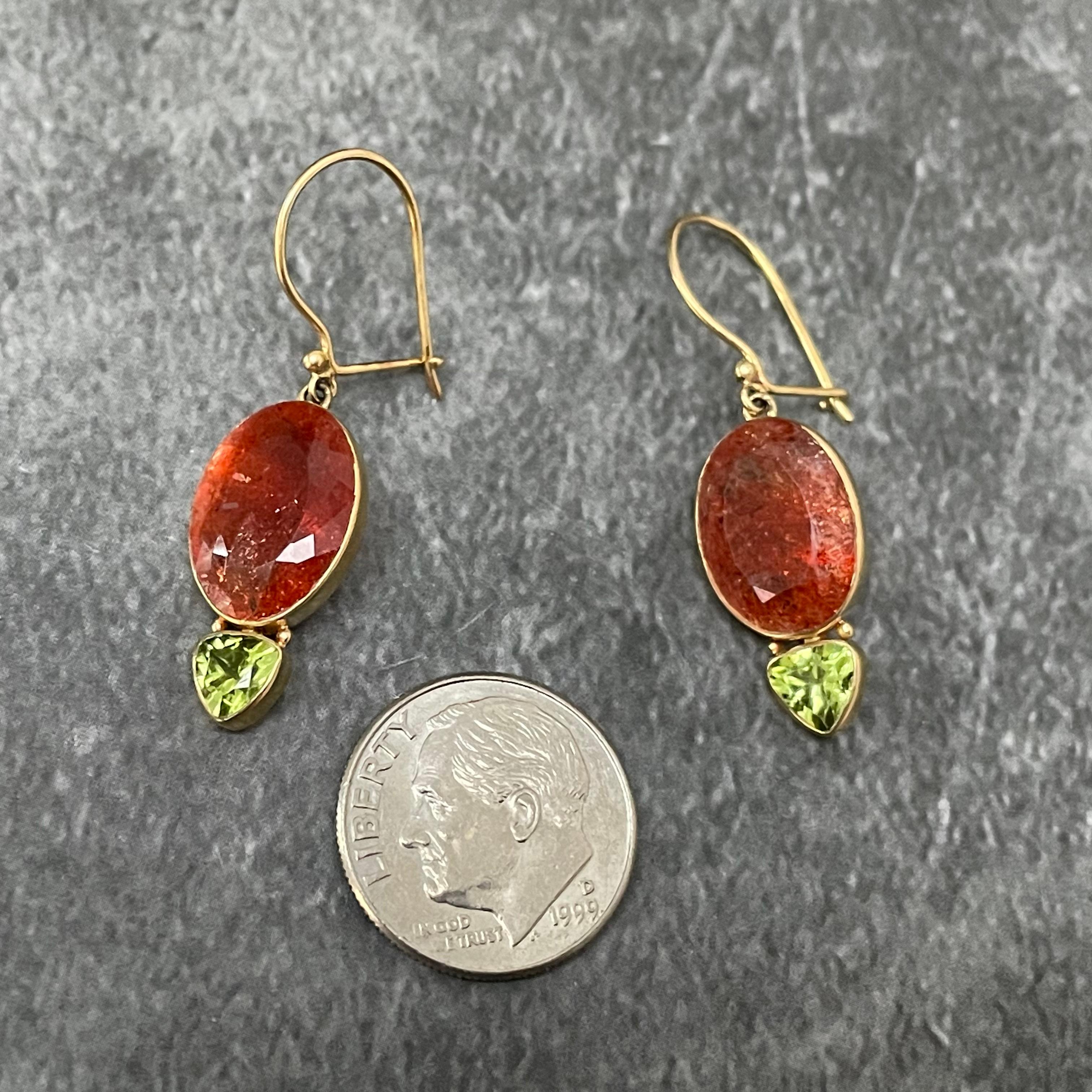 Beautiful complementary colors of 10 x 14 mm oval faceted sunstone and 5mm trillium facet peridot are suspended below safety clasp 18K gold ear wires in this unique pairing of orange and light green. Sure to be noticed!