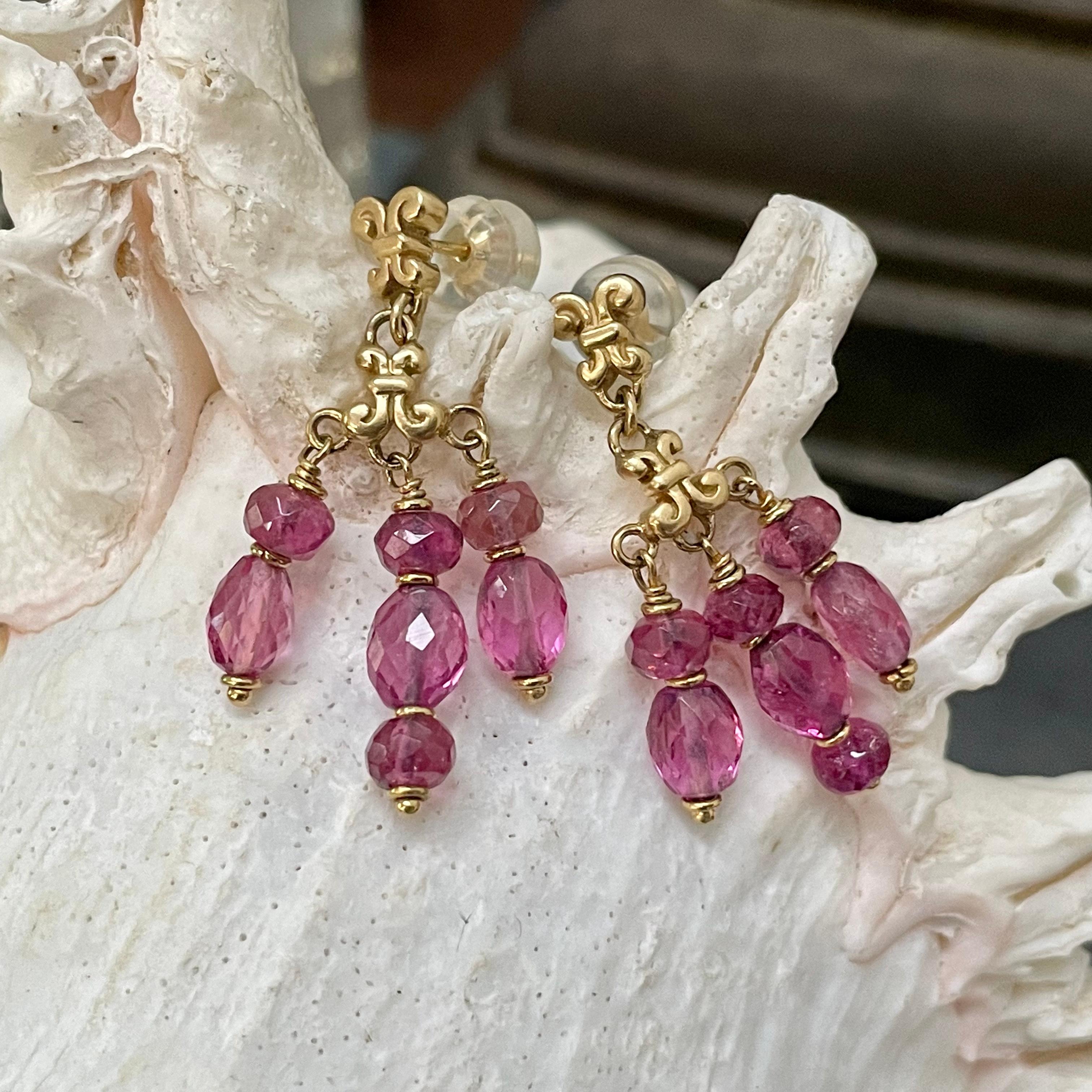 Uniquely designed wrapped spiral posts and similar opposing hanging components support graduated rose cut pink tourmaline beads with gold spacers in this elegant design. A lively interplay of pink to accent your look!