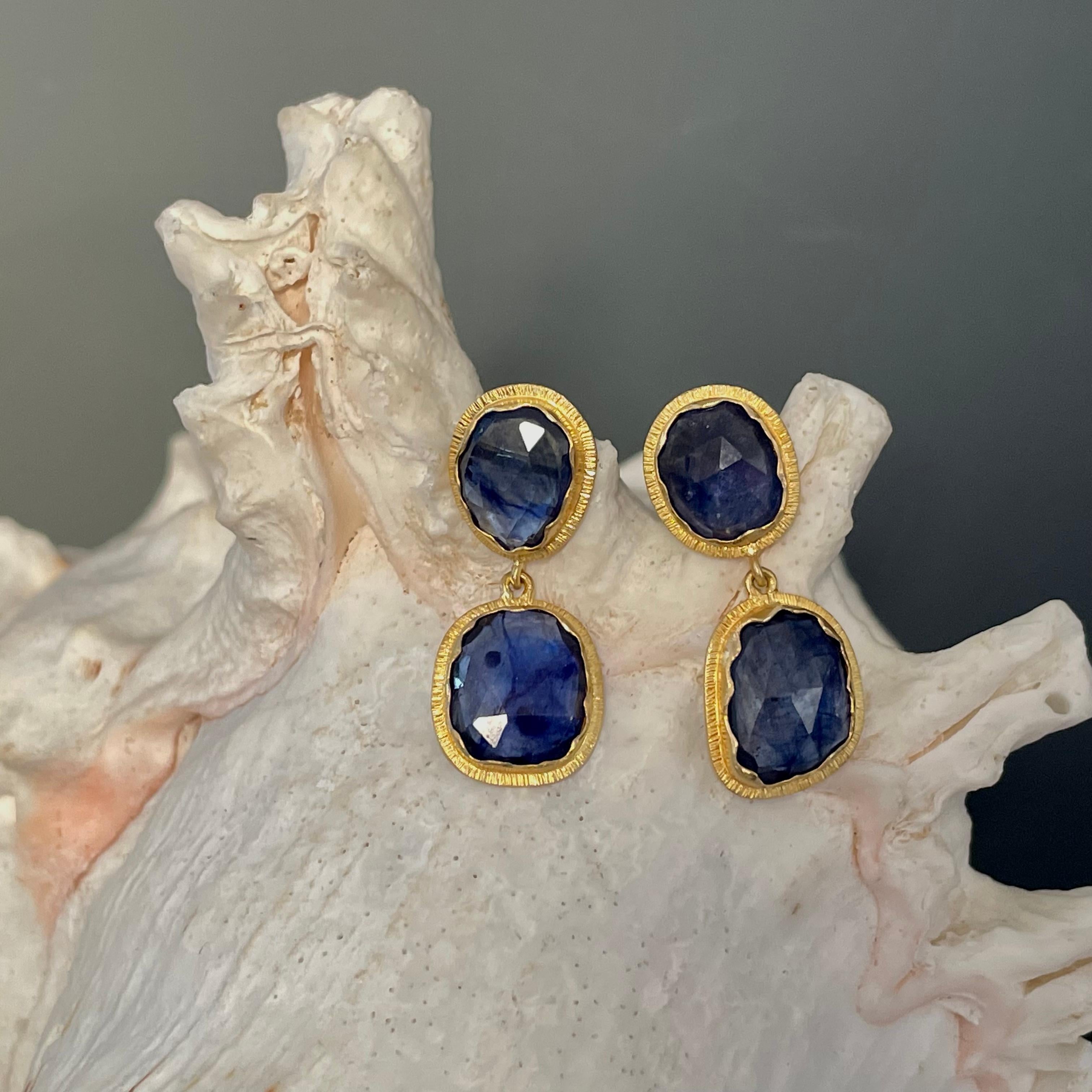Four slightly mix-shaped rose cut blue sapphires, approximately 7 x 9 mm to 8 x 10 mm in size, are set in organic wavy bezels with line texture accents in this interesting and attractive design. These are sure to please!
