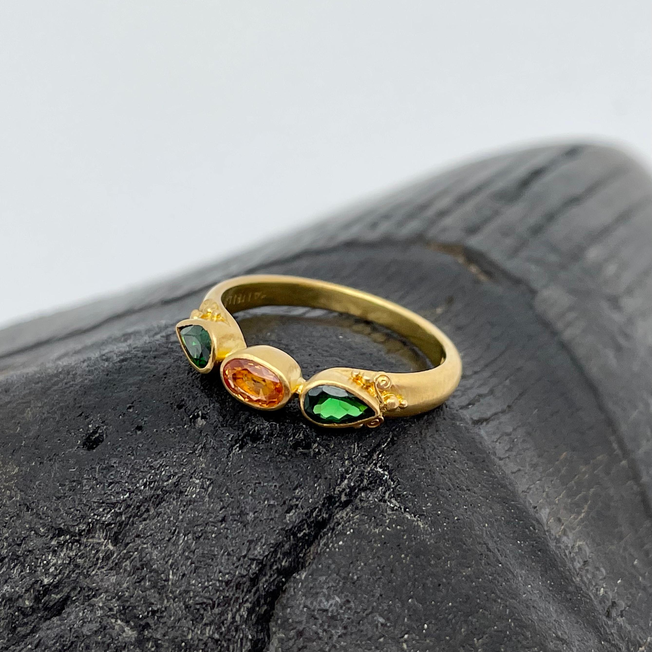 Two beautifully complementary colors of rare garnets: orange spessartite and green tsavorite, make a nice combination in this artisan crafted handmade high-karat gold setting ornamented with small spirals and 