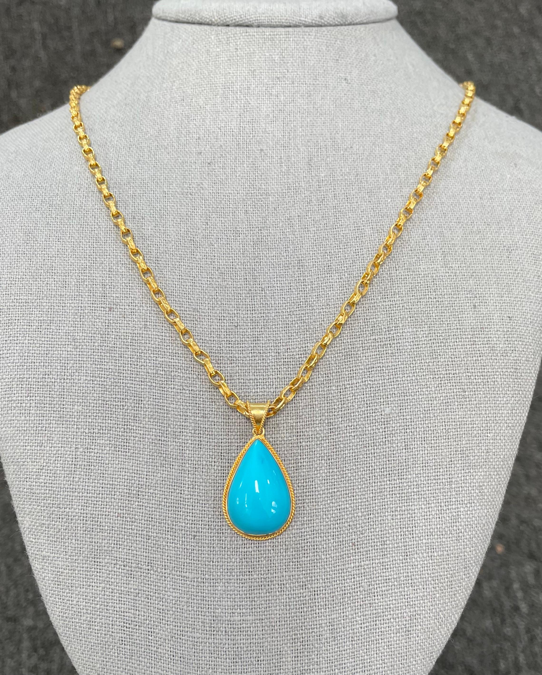 A flawless large 16 x 24 mm cabochon of Arizona Sleeping Beauty mine turquoise is set within a classic handmade braid wire 18K gold setting below a similar bail, all in matte-finish.
What a beautiful color...  The 18K handmade hammered chain shown