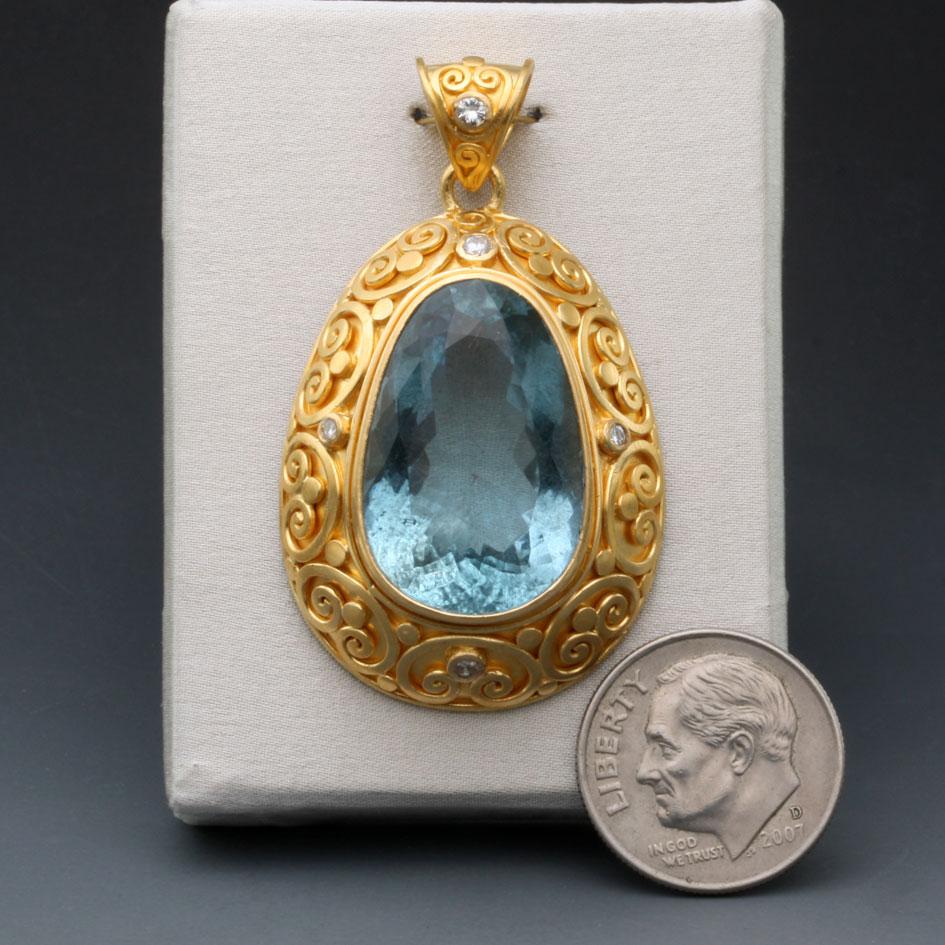 A shimmering faceted 18 x 22 mm rounded pear shaped Brazilian aquamarine is set within an exquisite artisinally handcrafted setting surrounded by five 1.8mm-2mm VS1 diamonds.  This heirloom piece is the result of 2 week's work of our finest