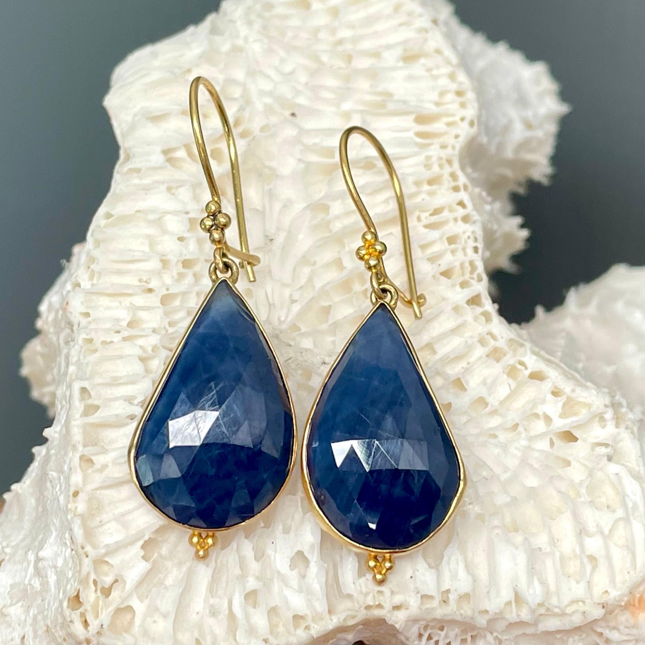 Two symmetrical rose-cut blue sapphire 12 x 19 mm drops are set in simple 18K bezels with 3 small granulation at bottom.  All suspended below safety clasp wires with a diamond 4 granulation accent.  Simple and Elegant!