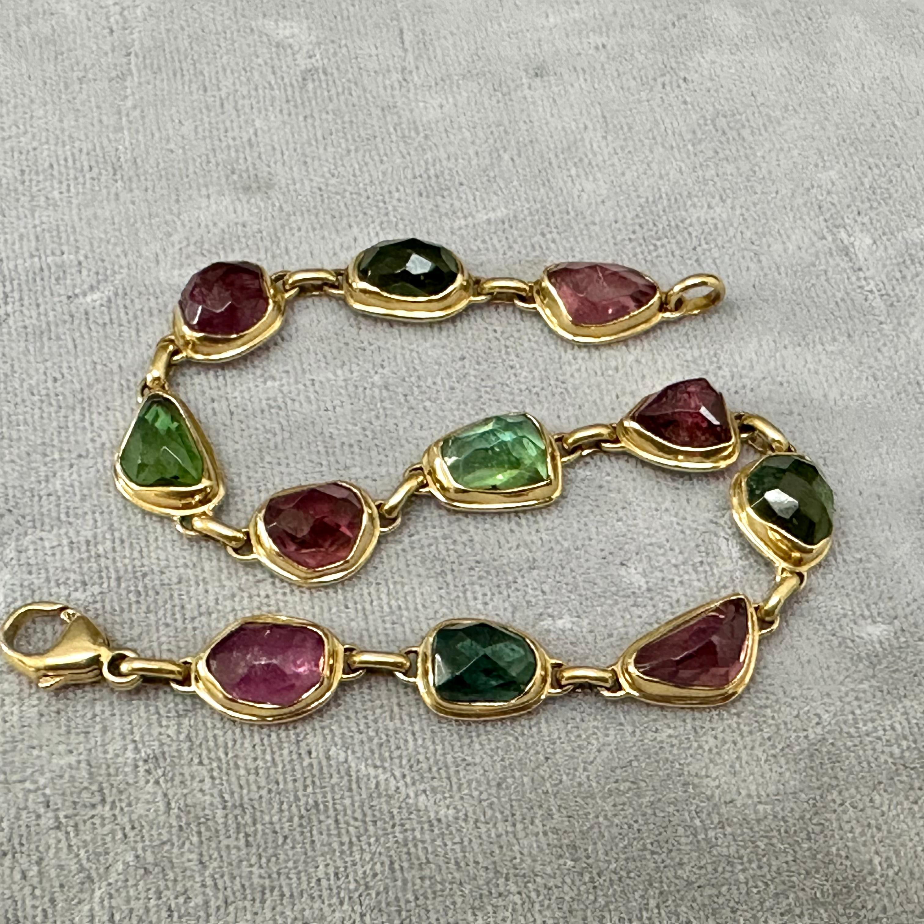 Eleven irregular shaped rose-cut tourmalines approximately 8 x 10 mm in size sparkle in multiple shades of pink and green in this attractive organic design. Each stone attracts the eye with the contrast to the surrounding matte-finish 18K gold