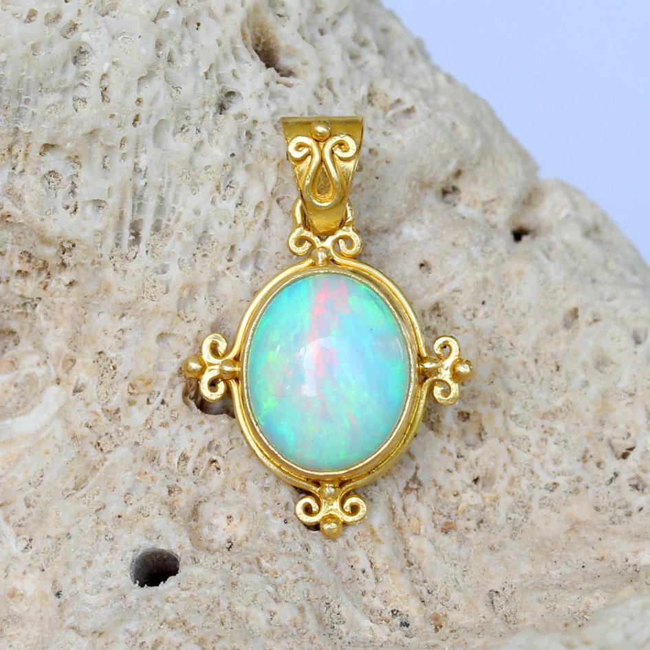 A very vibrant and flashing 9 x 11 mm oval cabochon 