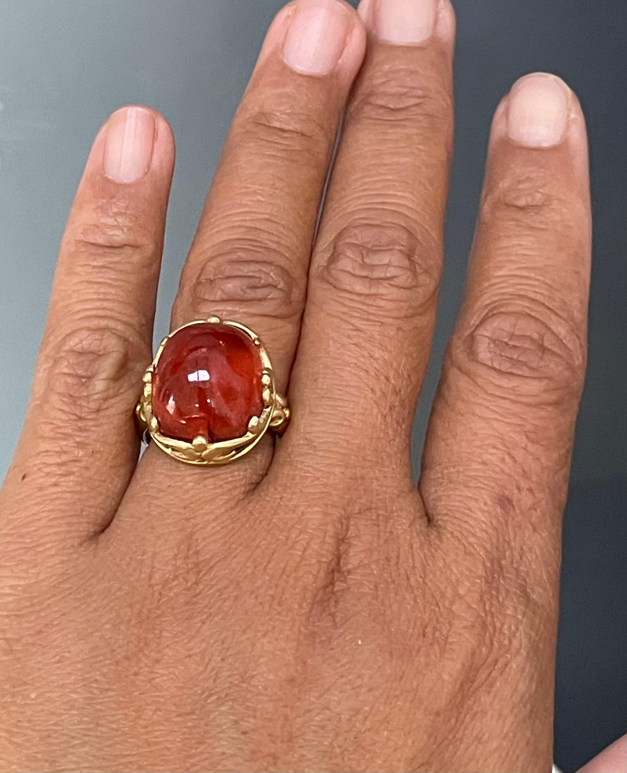 A delicious gumdrop of a 14 x 17 mm pink tourmaline cabochon is held in a Steven Battelle designed fluted and carved embrace. A stunner of a ring!  This is a really lively and magical stone, sure to please.  This ring is currently sized 7.5.  It is