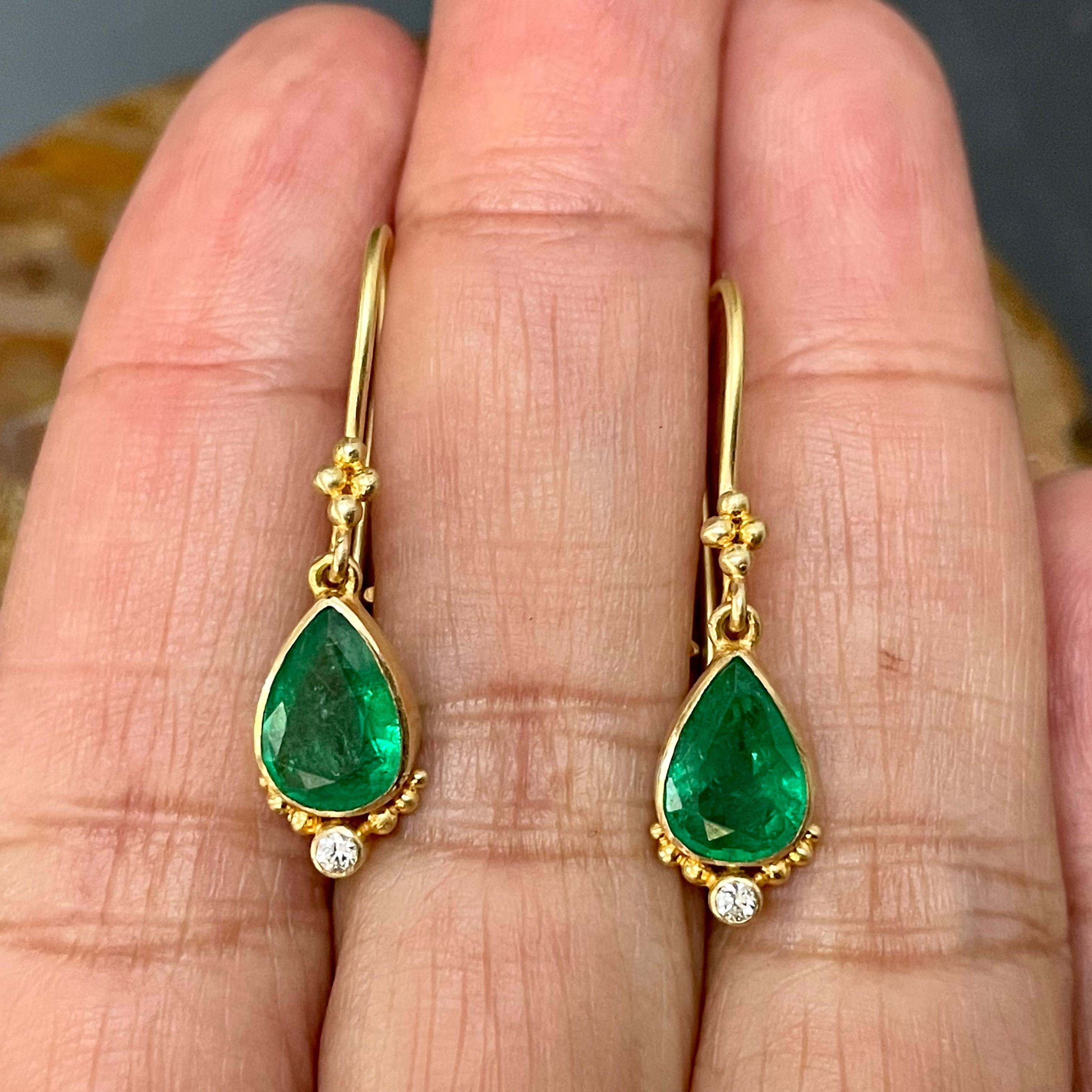 Two 6 x 9 mm pear shaped faceted emeralds are ornamented with sparkling 1.8 mm VS1 diamonds and graduated sized granulation below safety clasp wires in this ancient-inspired handmade design.  Delightful!