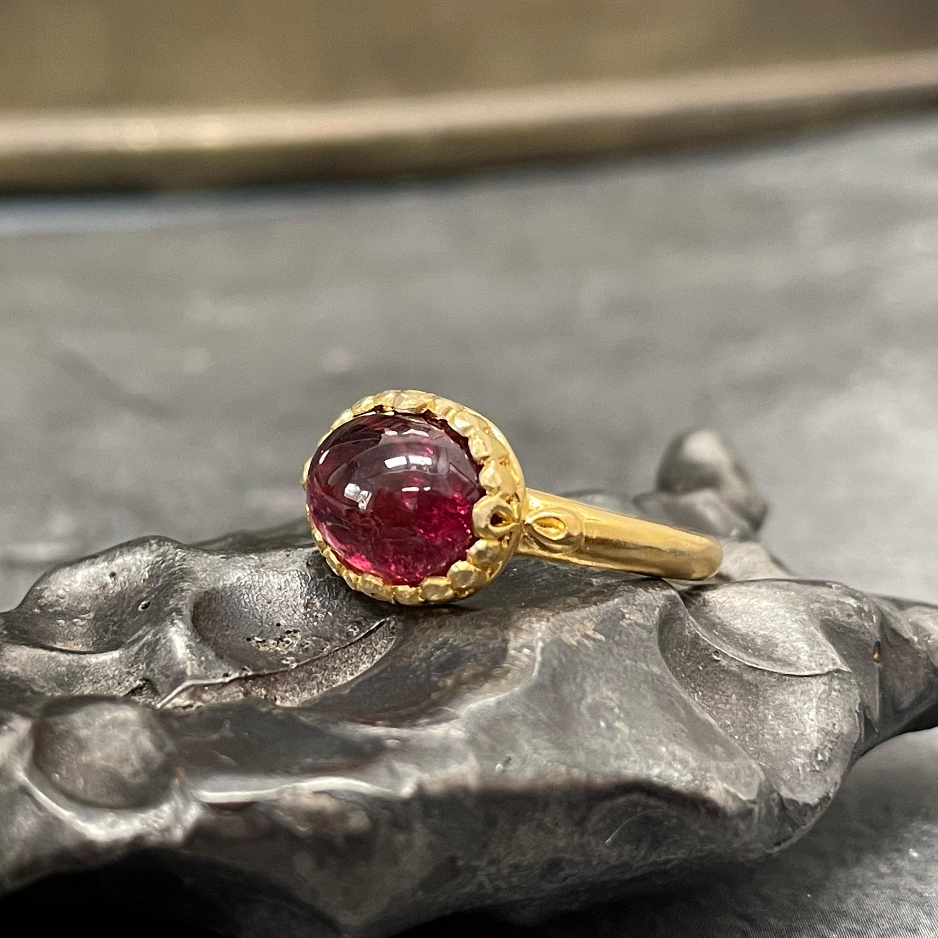 A nice luminous and lively 8x 10 mm oval pink tourmaline is set horizontally within a fluted bezel setting atop a slightly tapered 18K shank, all in matte finish.  A sweet and delicate ring for someone. Sometimes less is more!