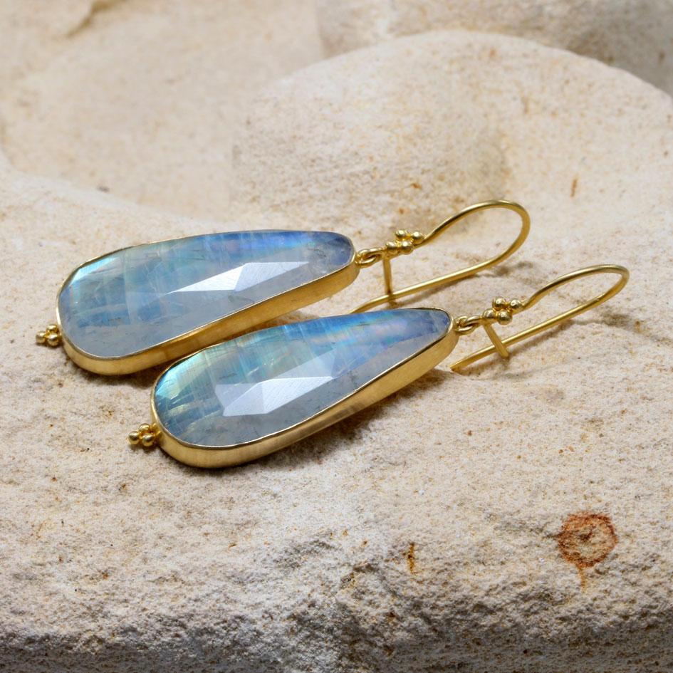 Two extremely lively 13 x 30 mm slightly irregular pear shaped rose faceted rainbow moonstones shimmer with shades of blues, greens, and gold in these beautiful earrings.  These stones are really incredible with their ever changing flashes of