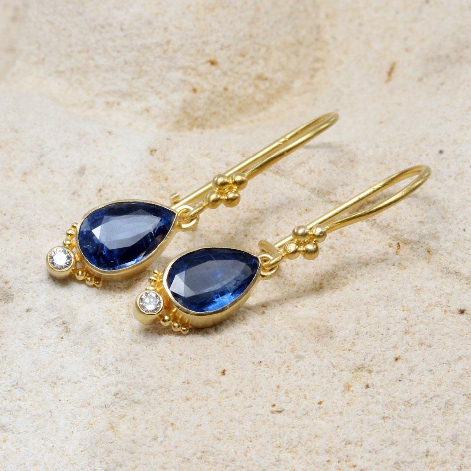 Two bright blue 6 x 9 mm pear shaped faceted kyanites are suspended below 18K gold safety-clasp ear wires with 4 